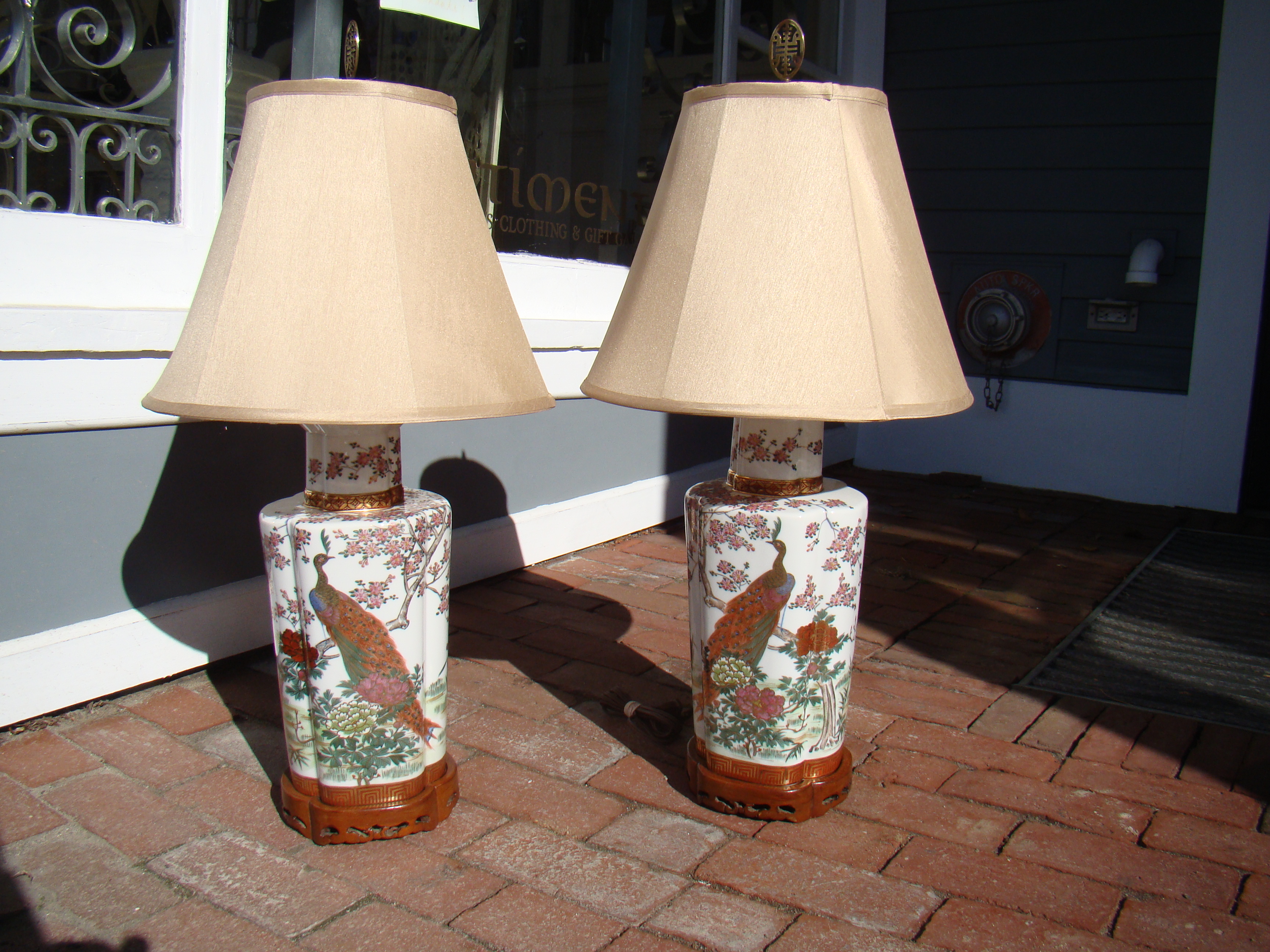 An extremely attractive pair of vintage teakwood mounted Asian lamps