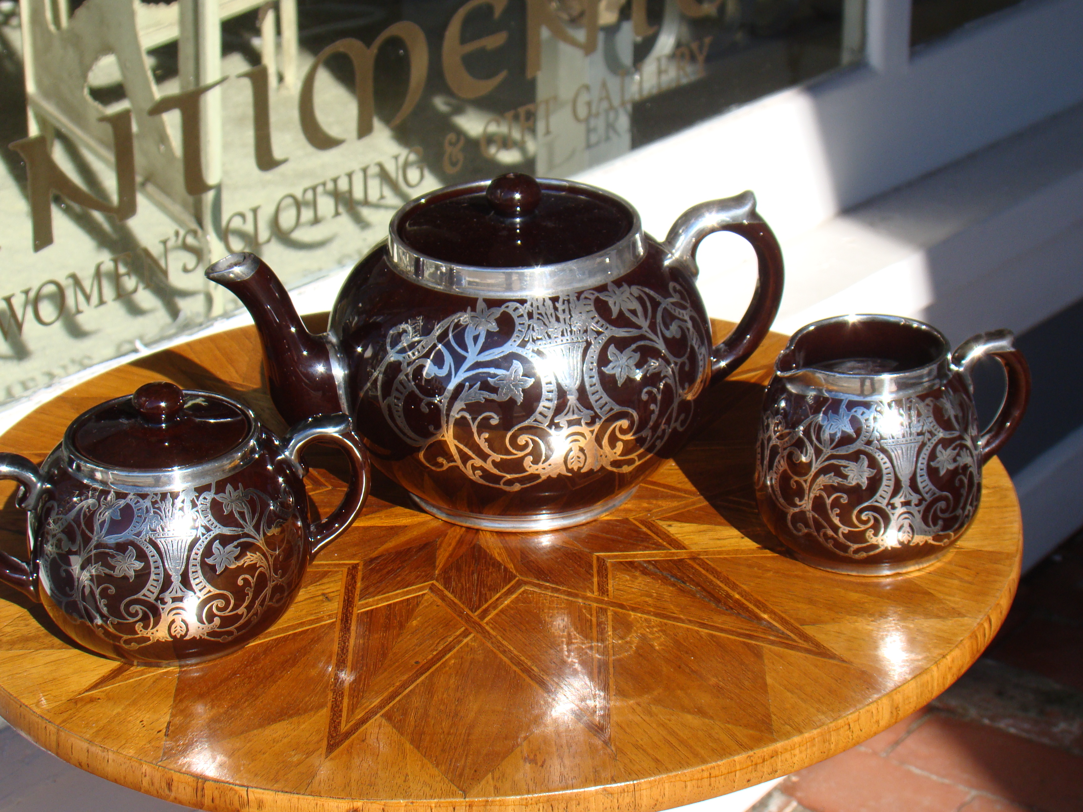 A stunning vintage Art Nouveau period silver overlay teapot, creamer and sugar by Gibsons