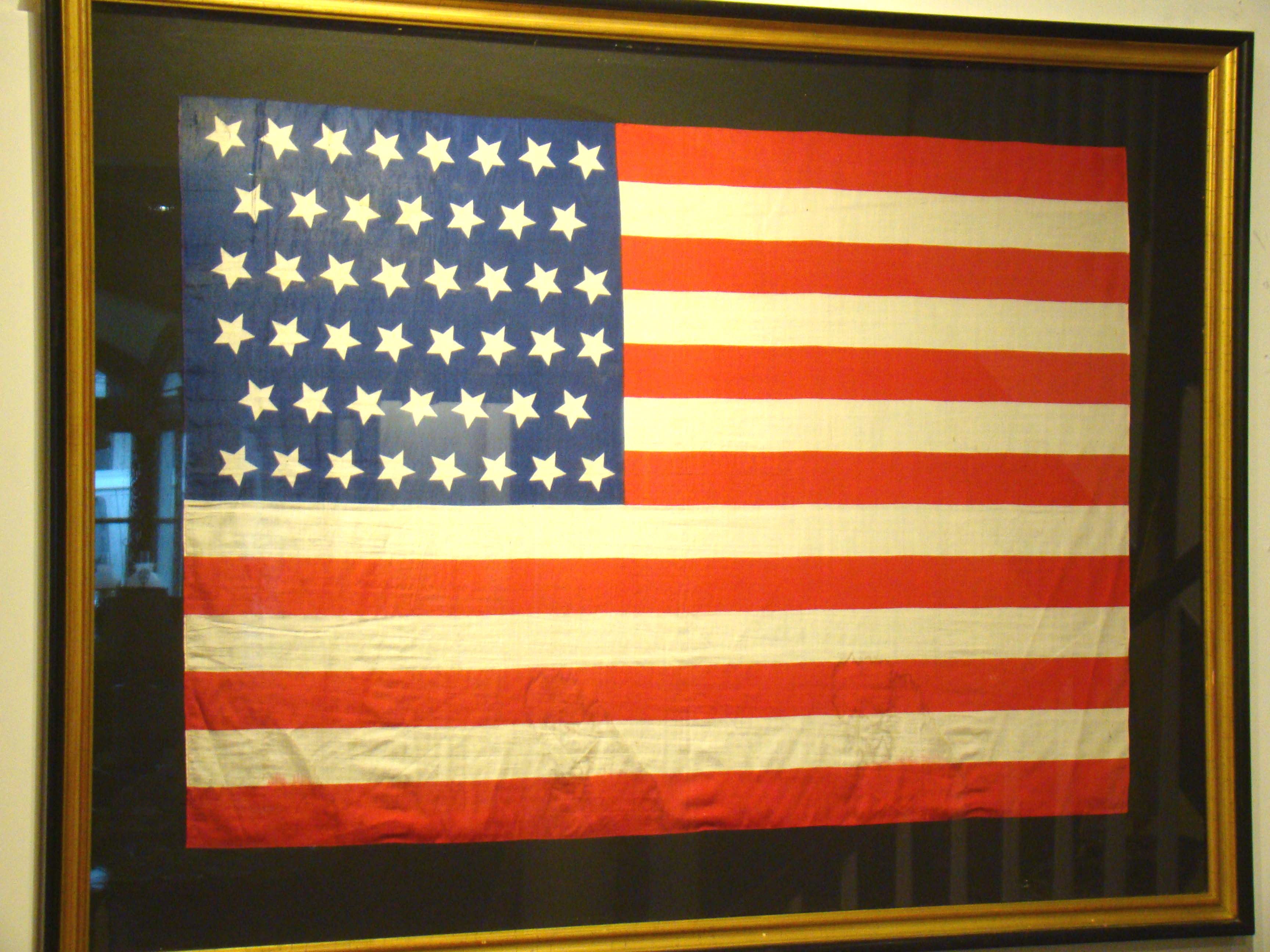 A fine 46 star American parade flag made to celebrate Oklahoma joining the Union on July 4, 1908