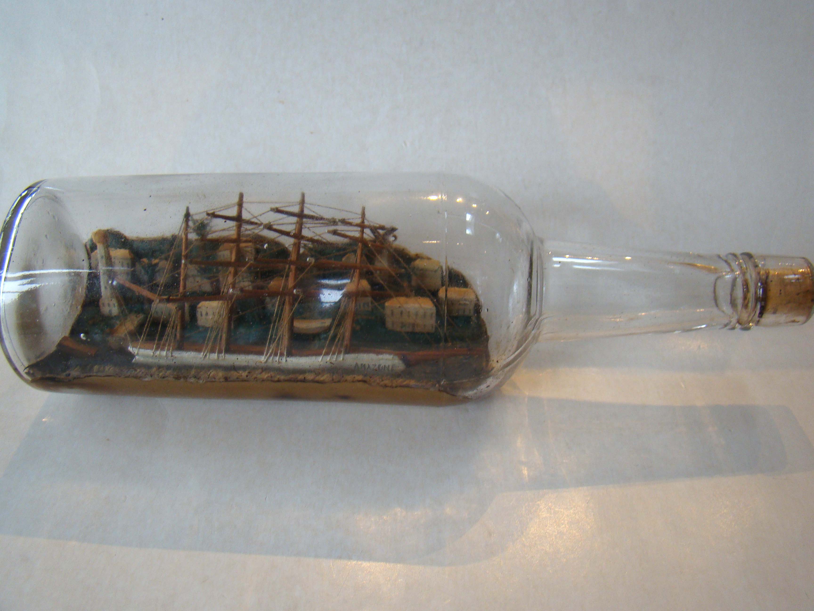 A four-masted ship-in-a bottle with a highly detailed and extensive village scene in the background circa 1890-1900. — image 2