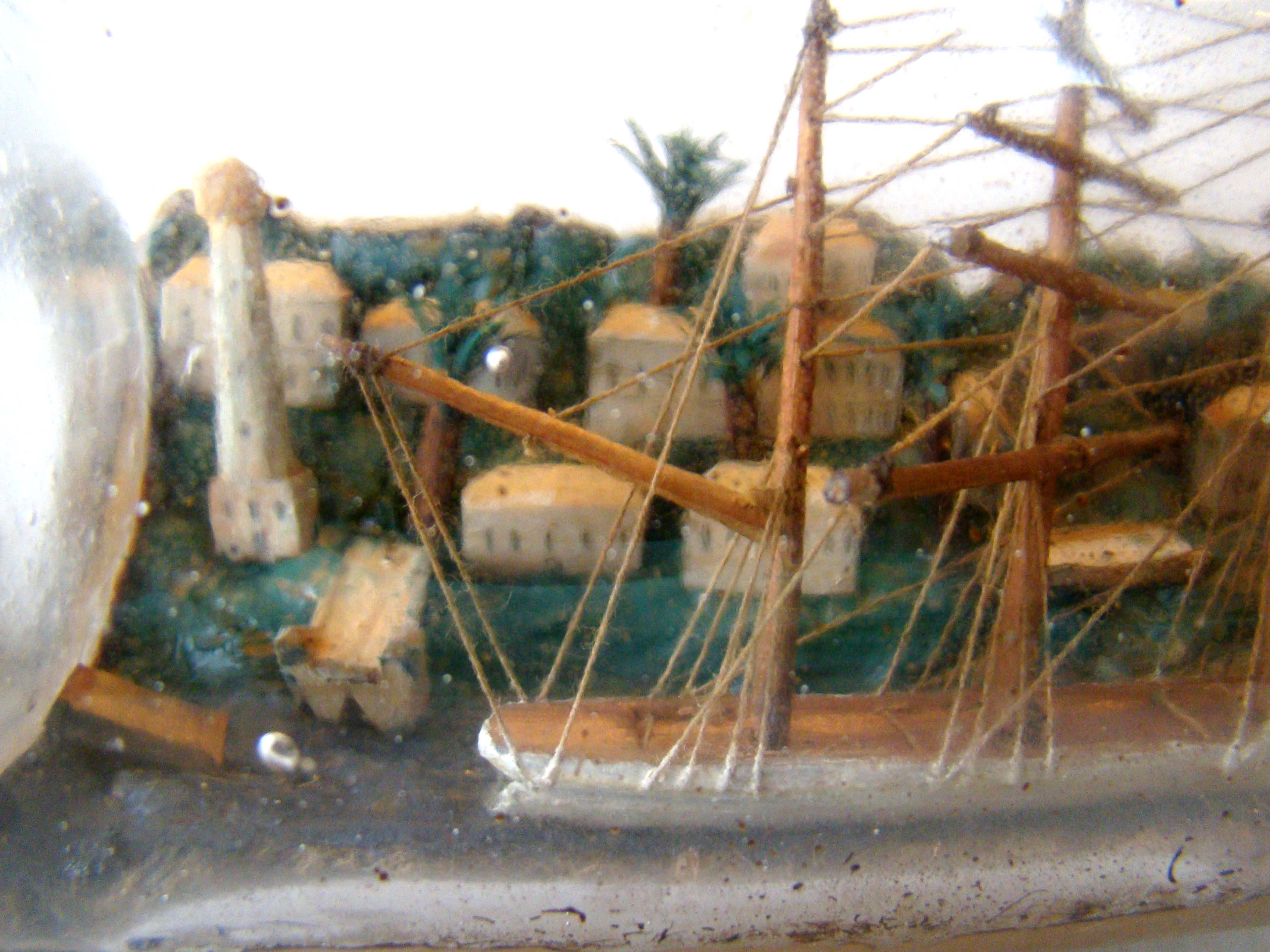 A four-masted ship-in-a bottle with a highly detailed and extensive village scene in the background circa 1890-1900. — image 3