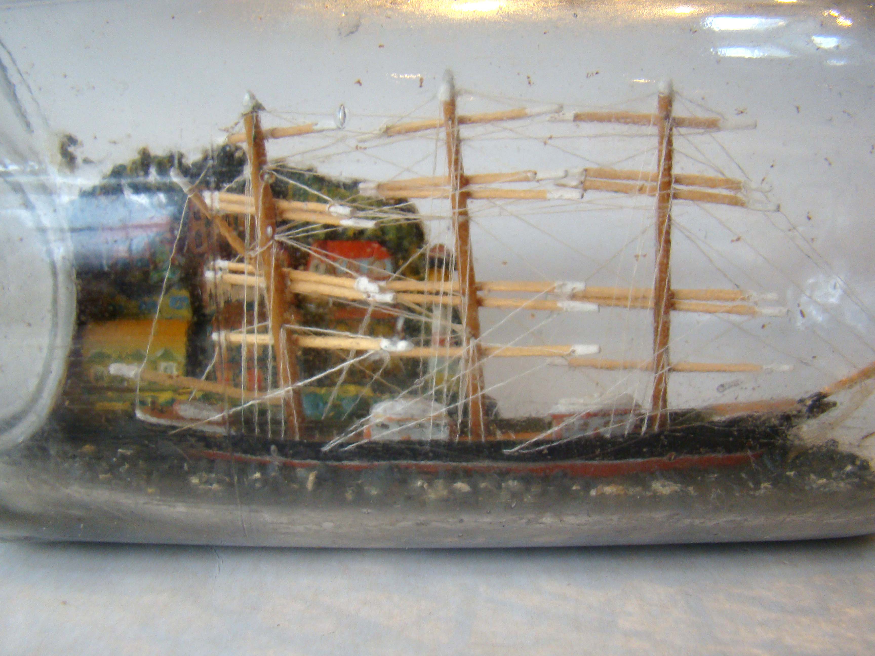 A late 19th century ship-in-a bottle with a wonderful village scene in the background — image 2