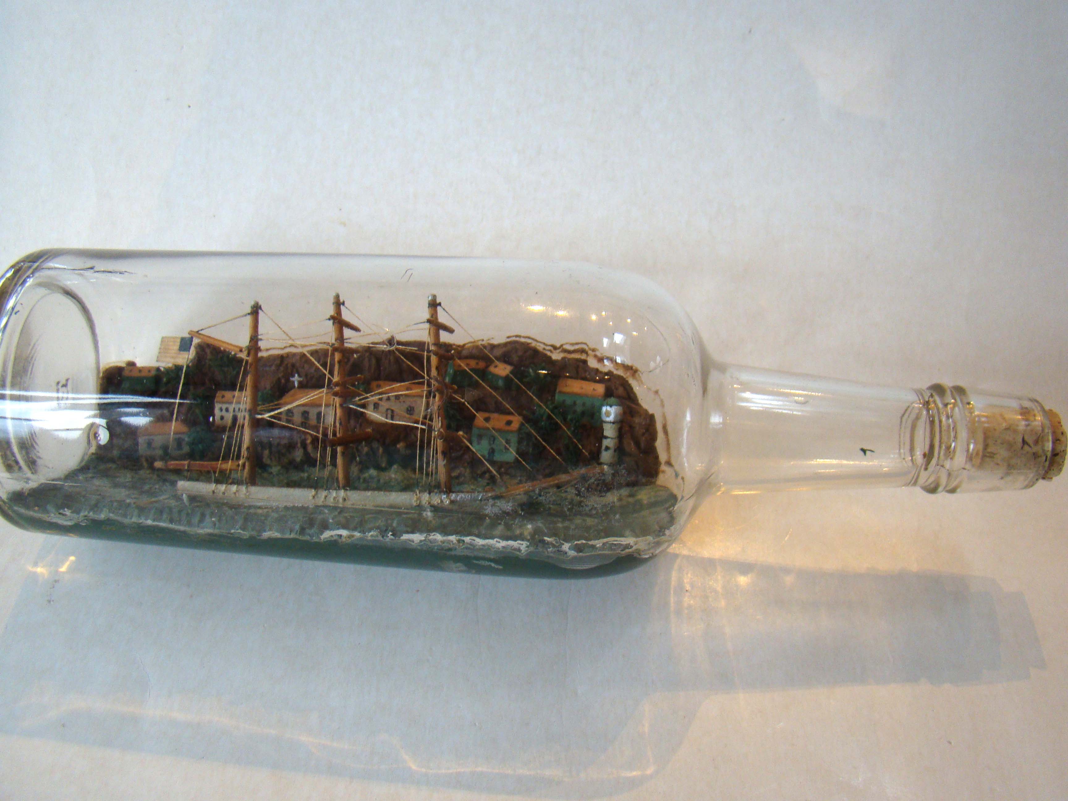 A circa 1920 Three-masted barque flying the American flag with a wonderful village in the background