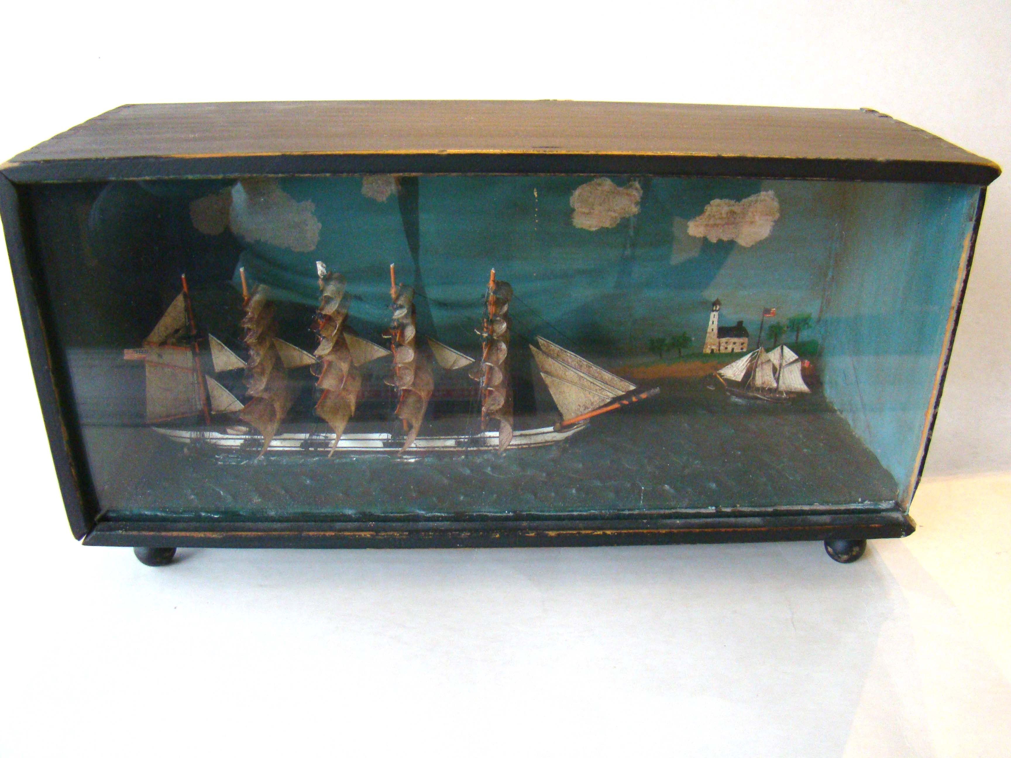A wonderful and quite small cased 19th century diorama featuring a five-masted ship under sail flying an American flag.