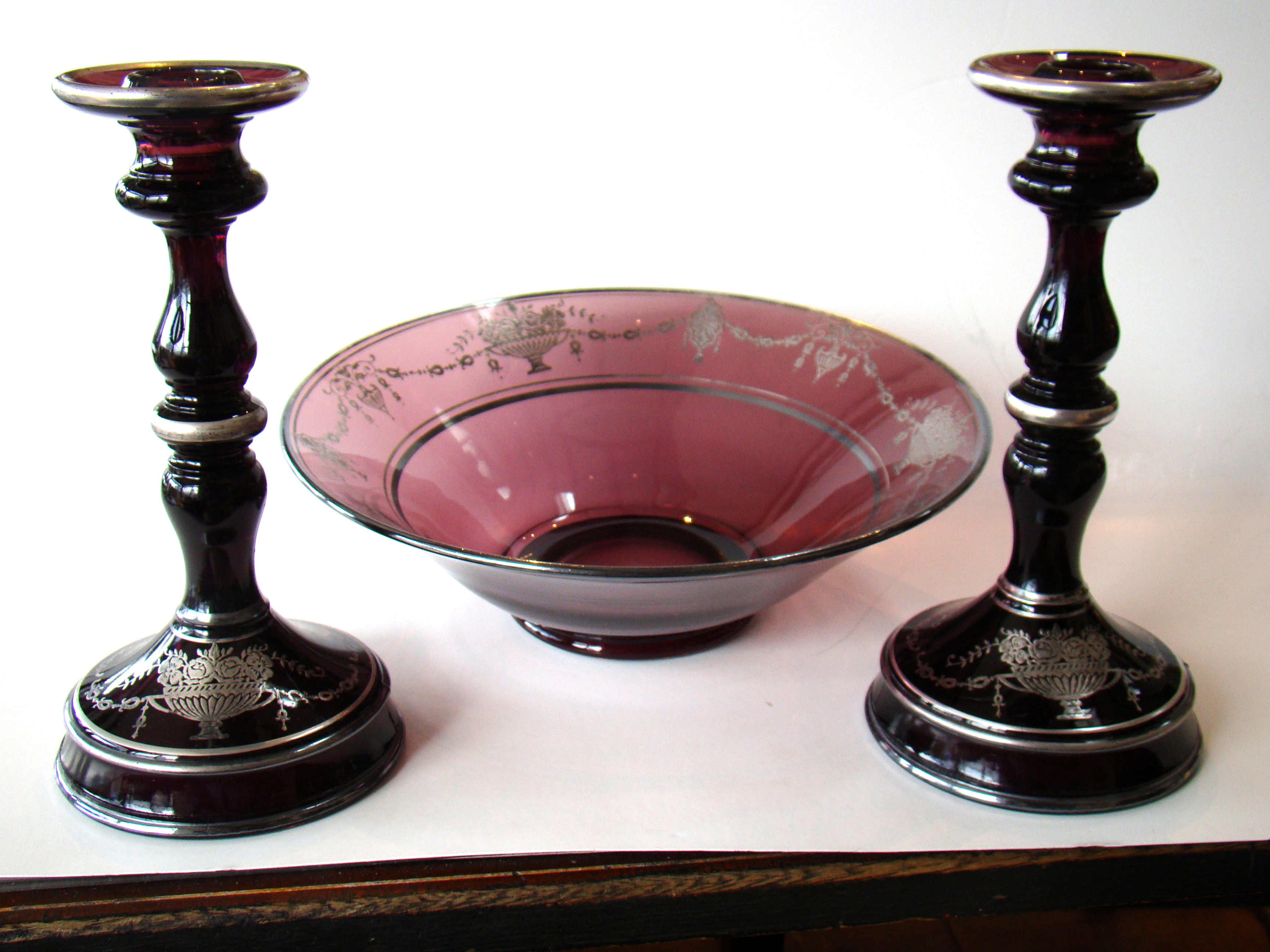 A gorgeous vintage set of silver inlaid amethyst glass candlesticks with matching bowl circa 1920