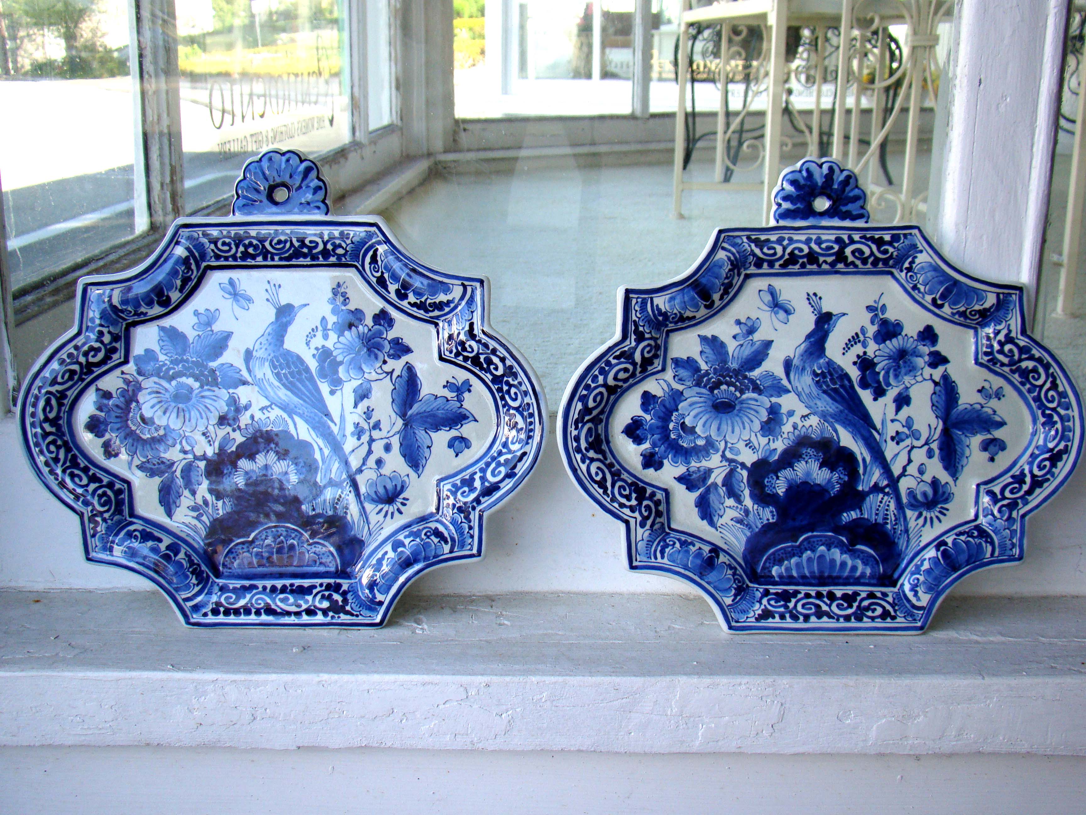 A beautiful pair of hand painted Dutch delft wall plaques, probably 20th century