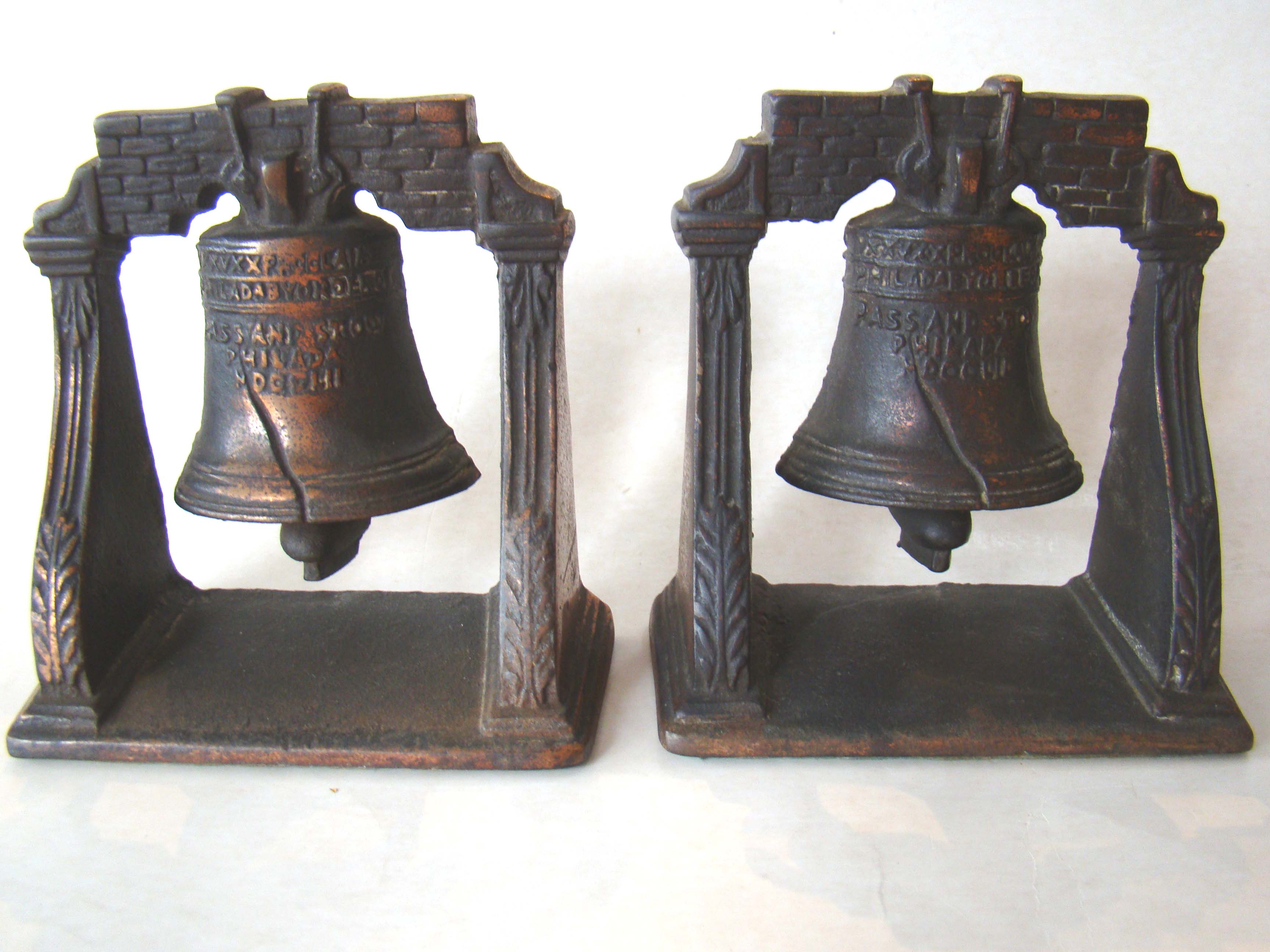 A pair of vintage cast iron Liberty bell bookends circa 1925
