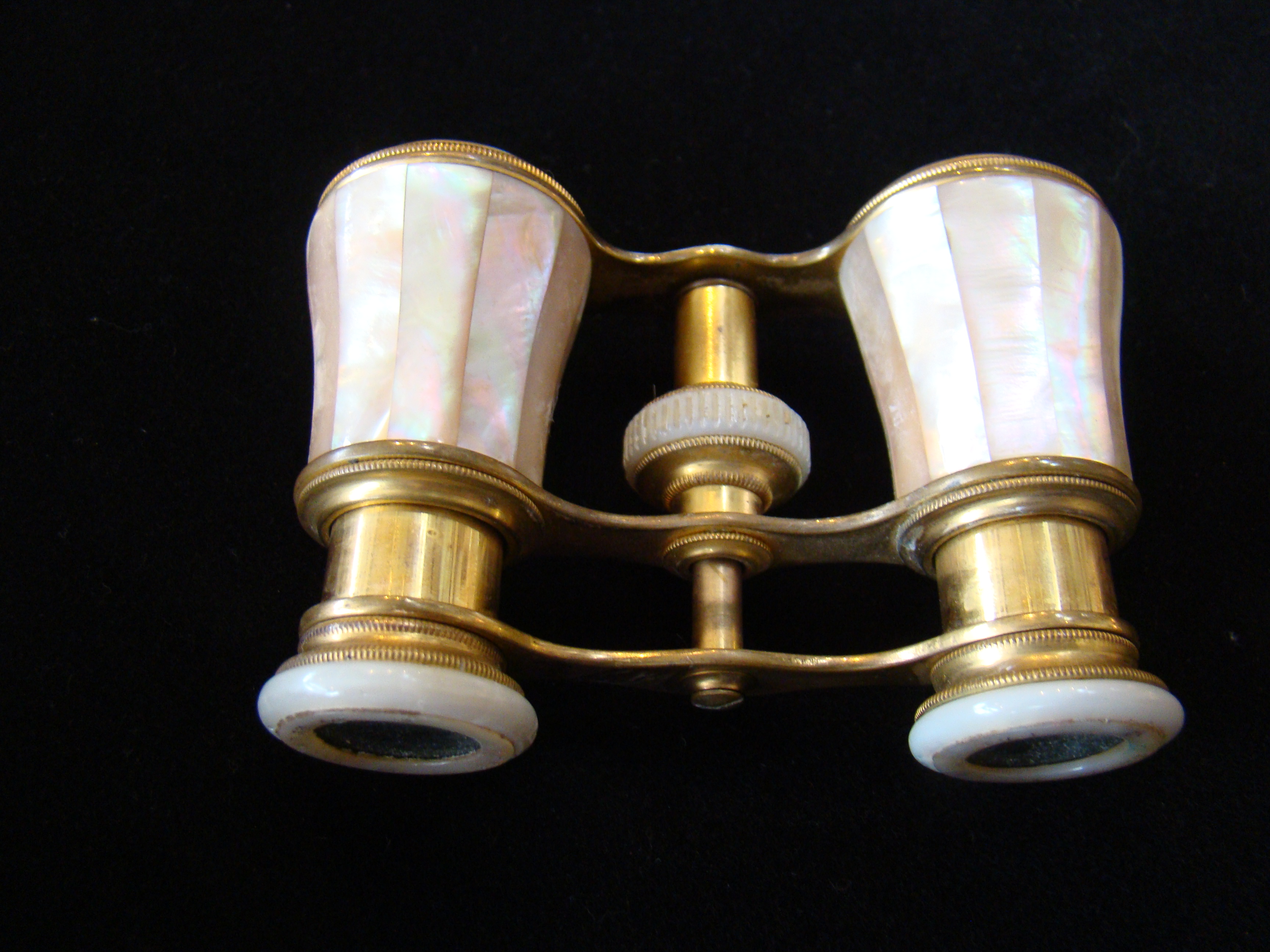 A pair of late 19th century mother-of-pearl mounted French opera glasses by Colmont