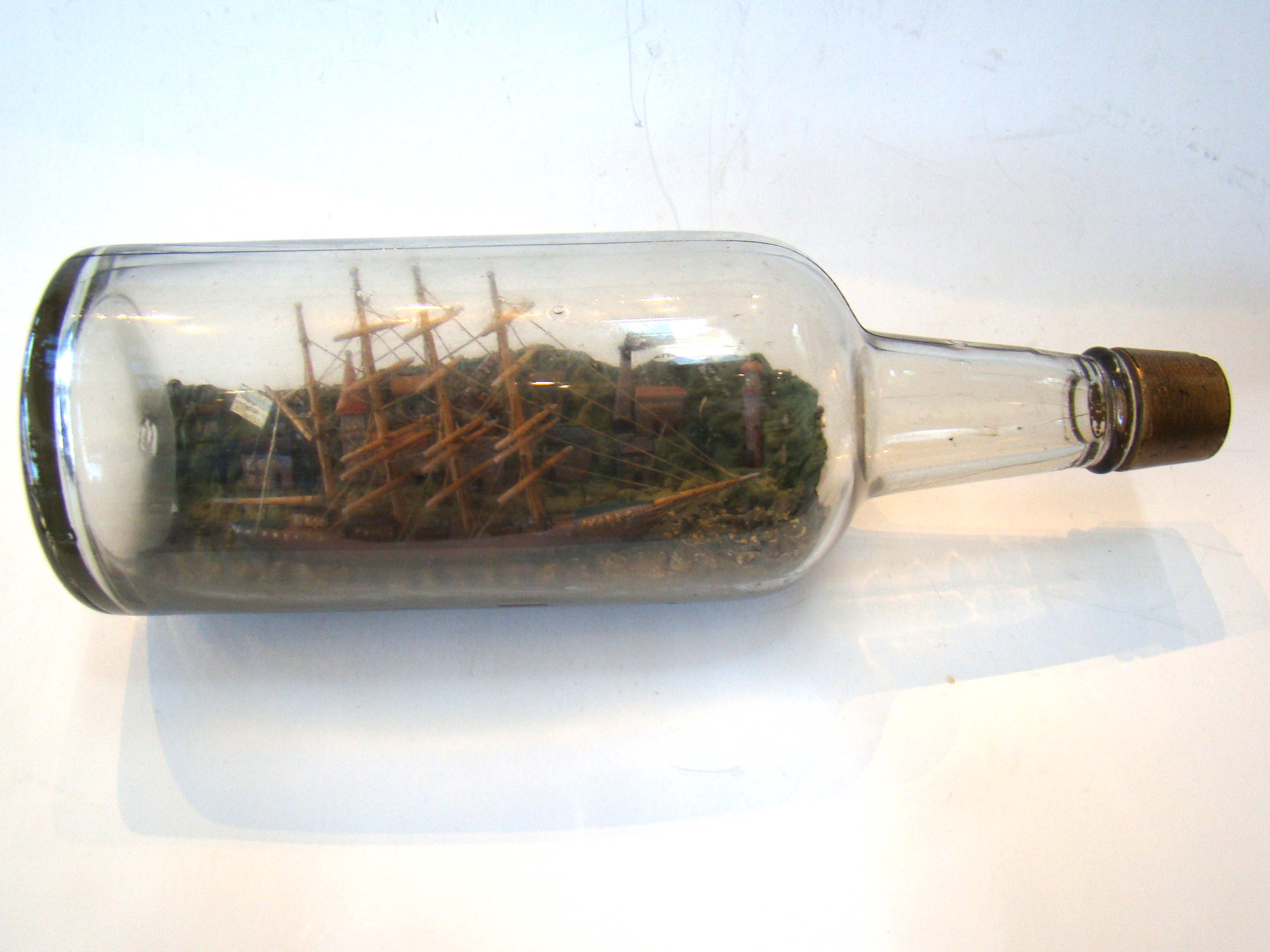 A wonderful vintage ship-in-a bottle circa 1890-1910 with elaborate and detailed village in the background.