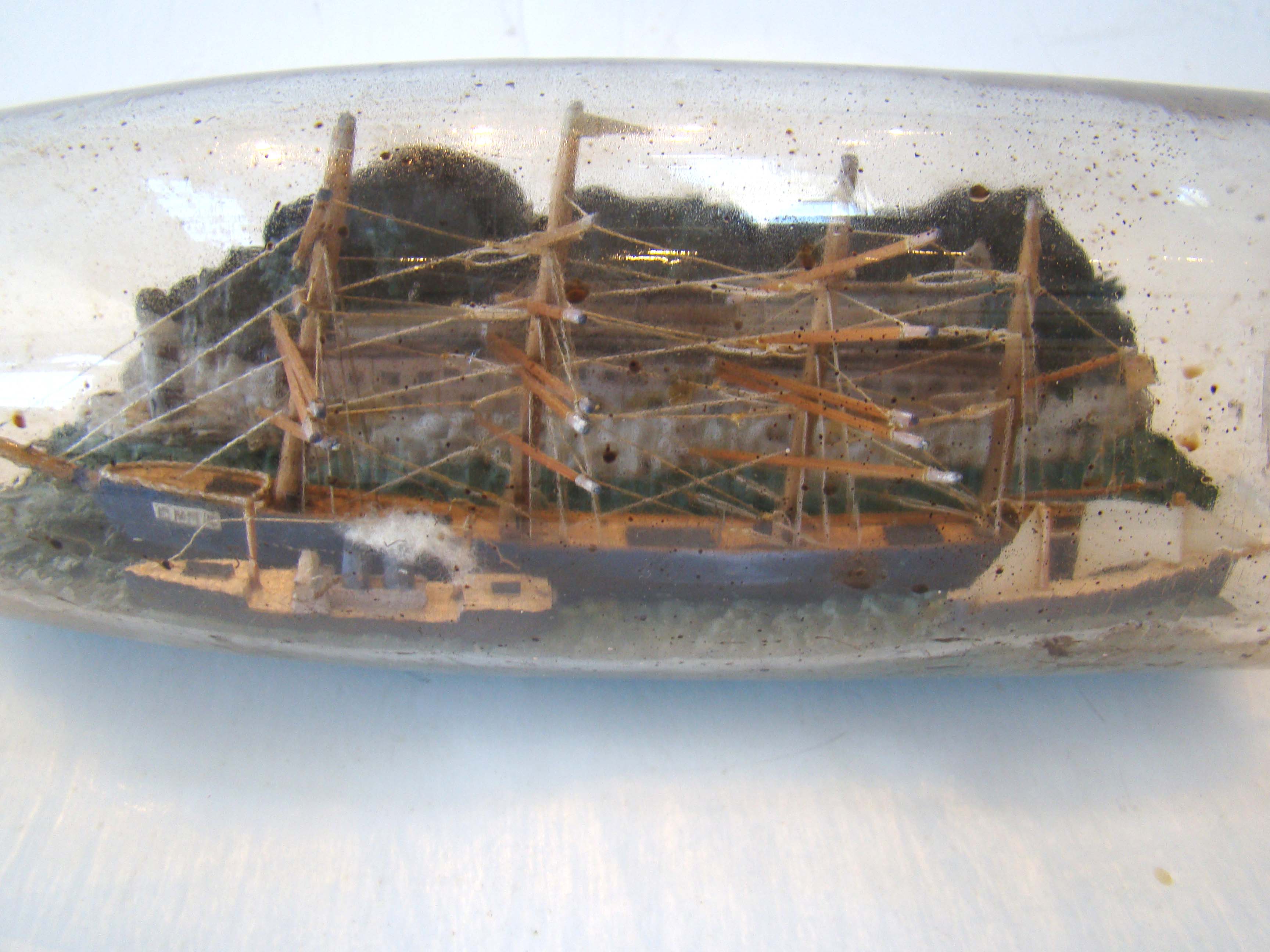 A fine vintage four-masted ship-in-a bottle circa 1910-1920 with two smaller ships in the foreground. — image 3