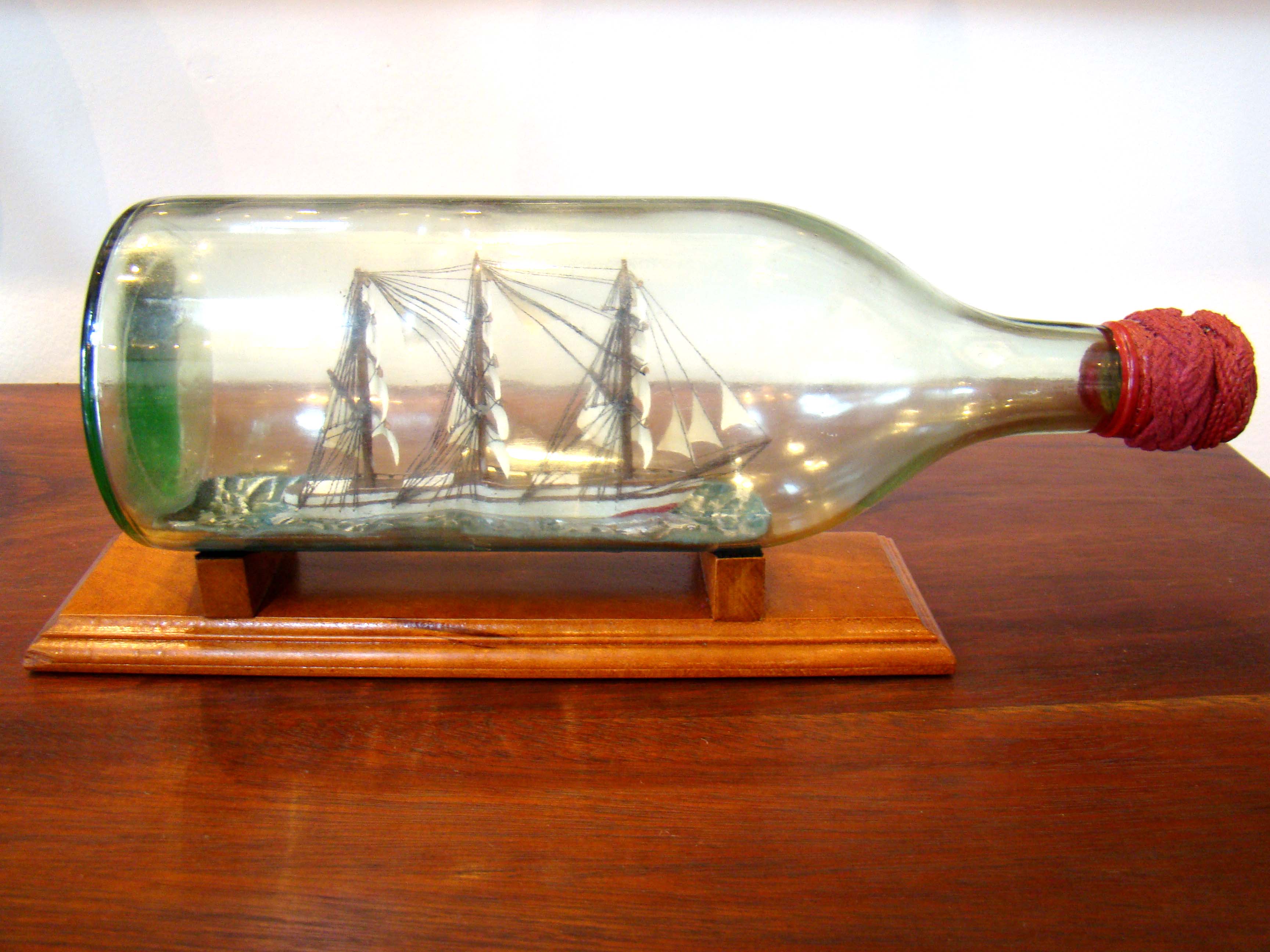 An attractive mid-century three-masted ship in a bottle