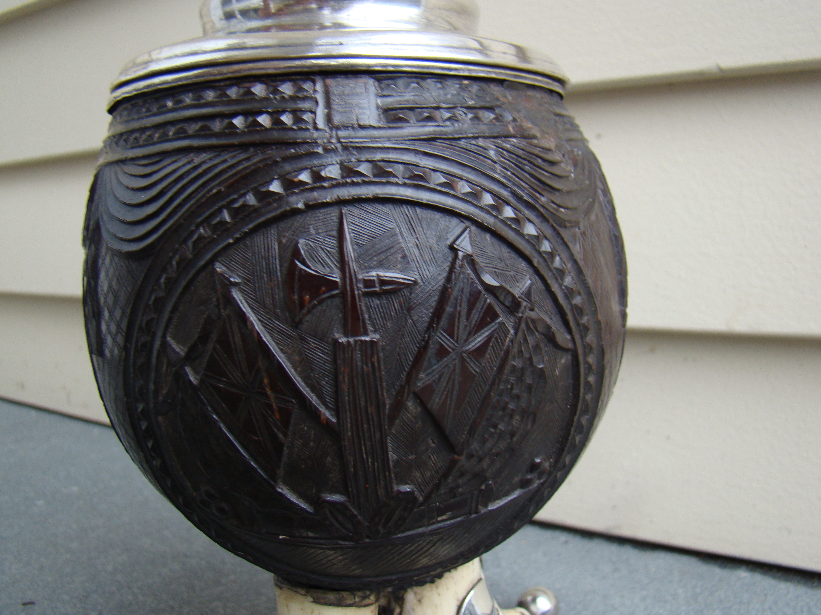 A fine and rare early 19th century silver mounted carved coconut shell covered cup on four whale's teeth — image 2