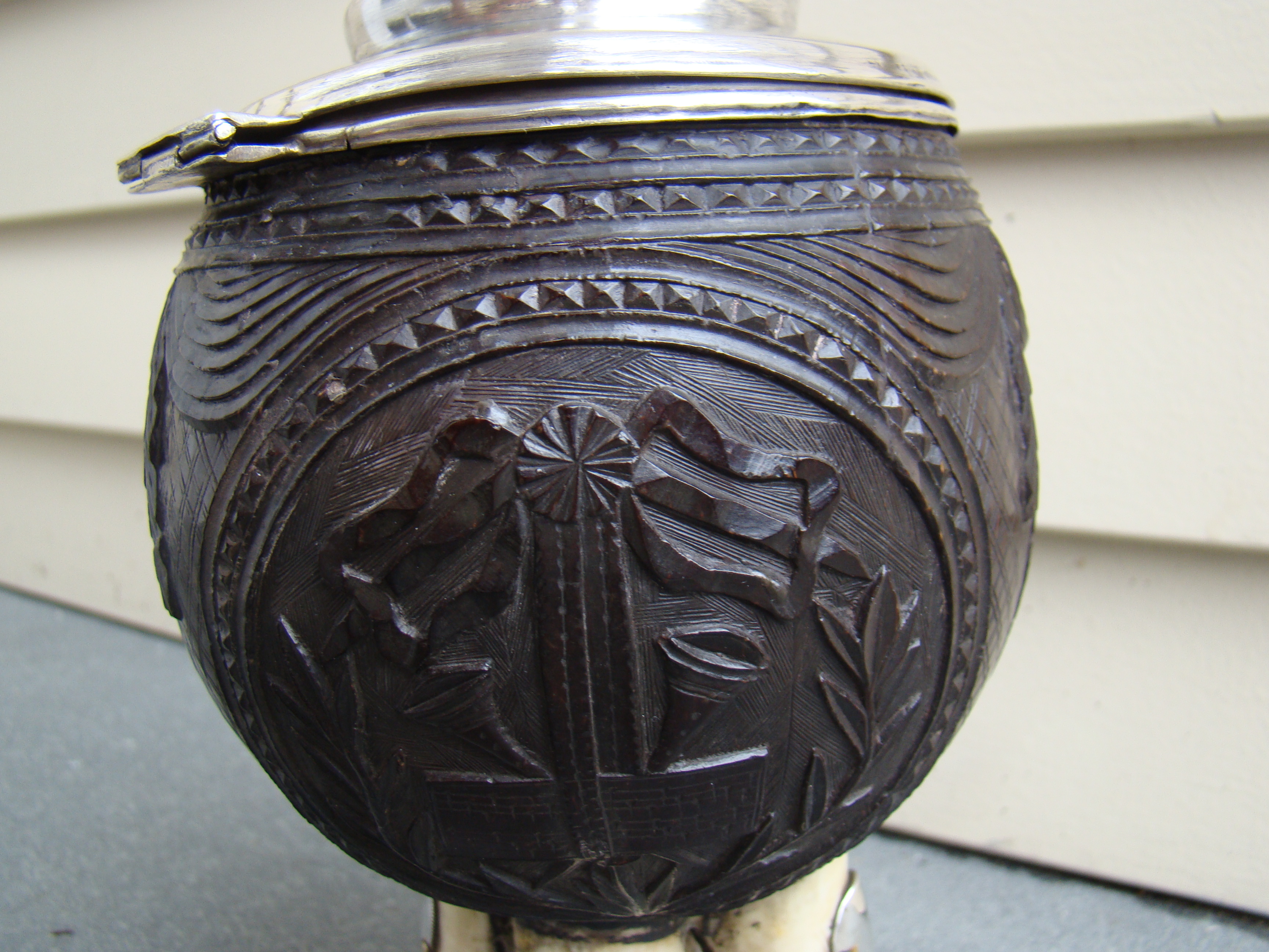 A fine and rare early 19th century silver mounted carved coconut shell covered cup on four whale's teeth — image 3