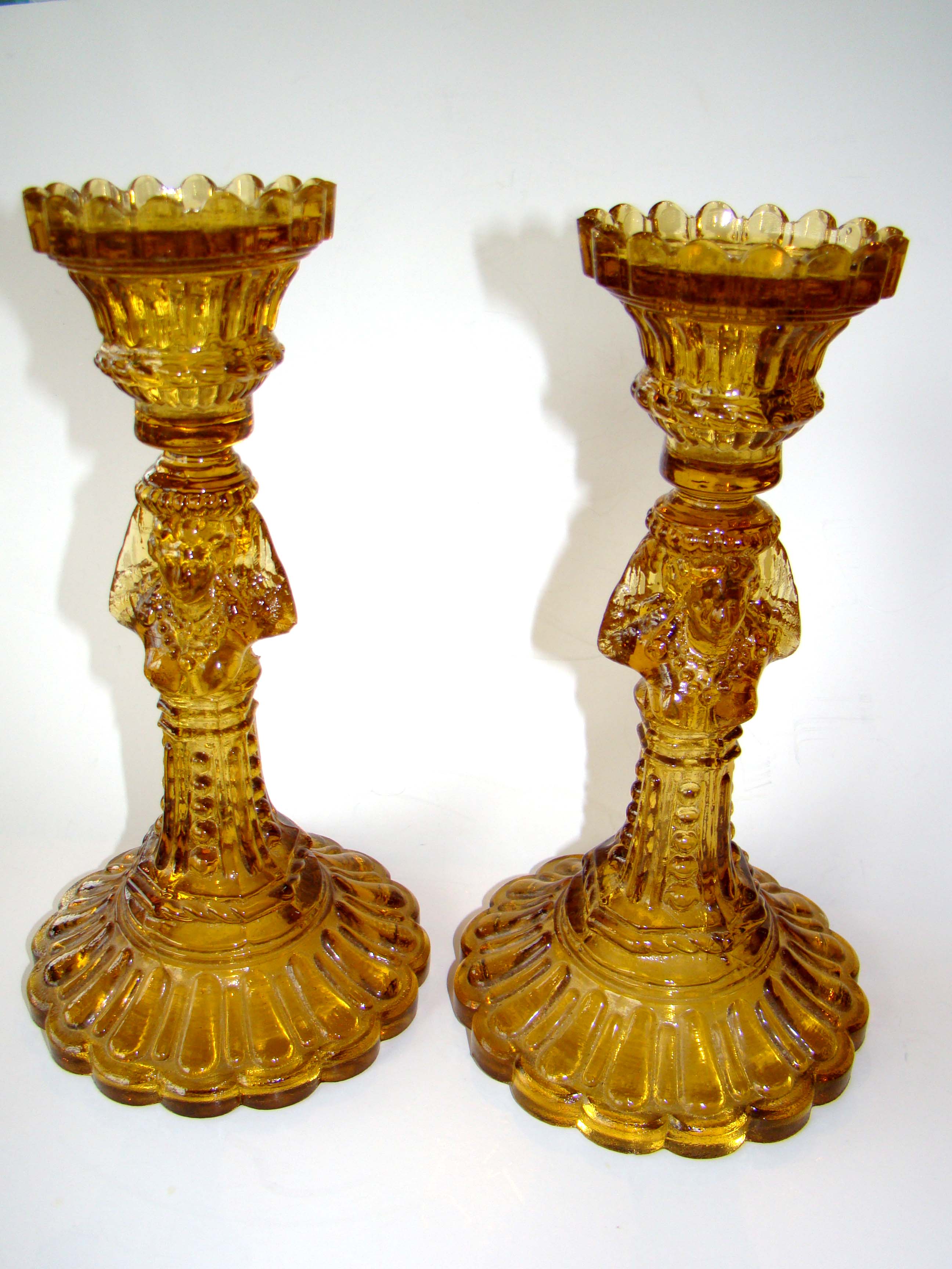 An exceptionally fine and RARE pair of Victorian amber glass candlesticks with female busts
