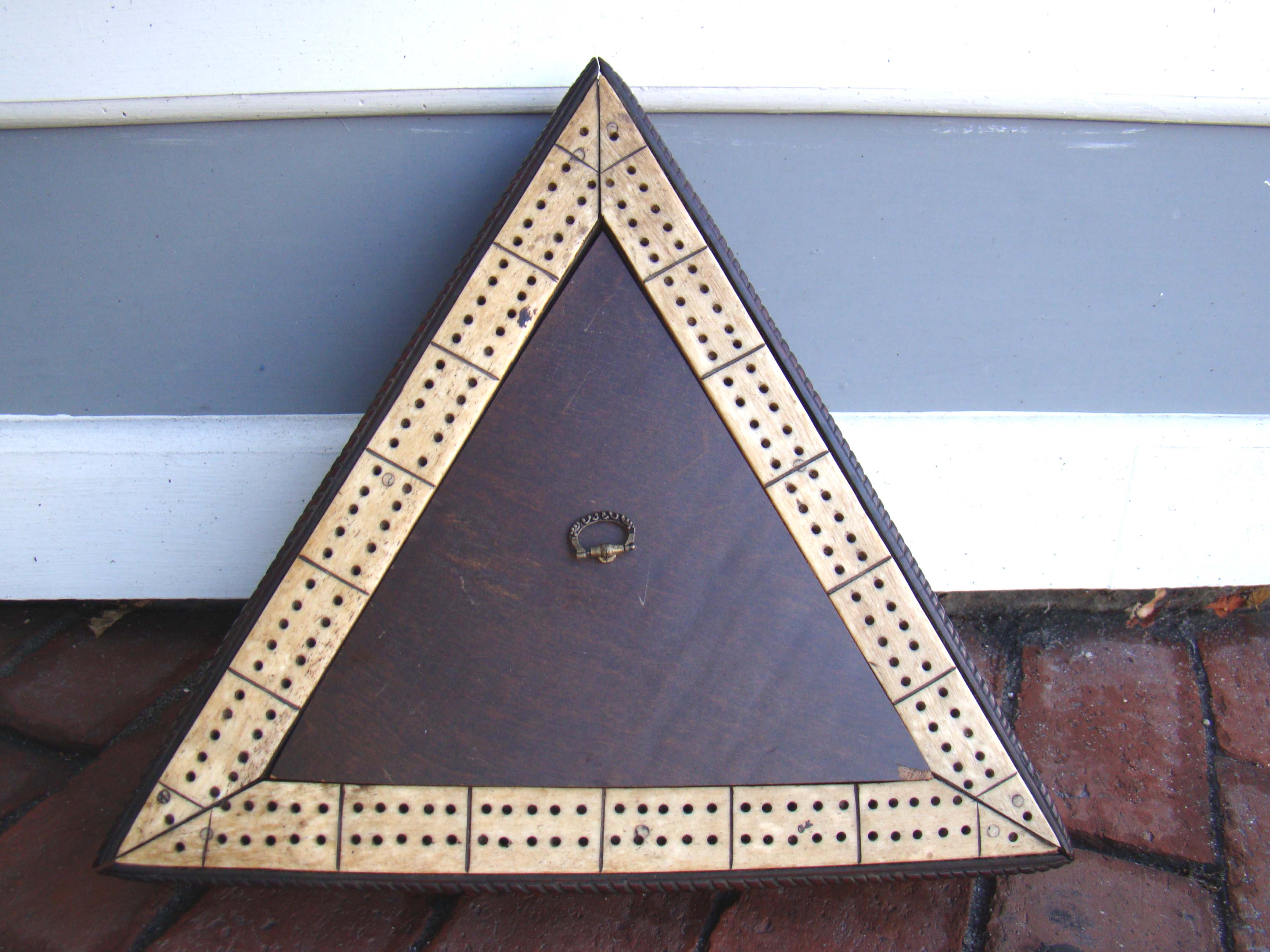 A rare sailor-made triangular whalebone cribbage board mounted on a mahogany base with rope twist border made circa 1830-1850