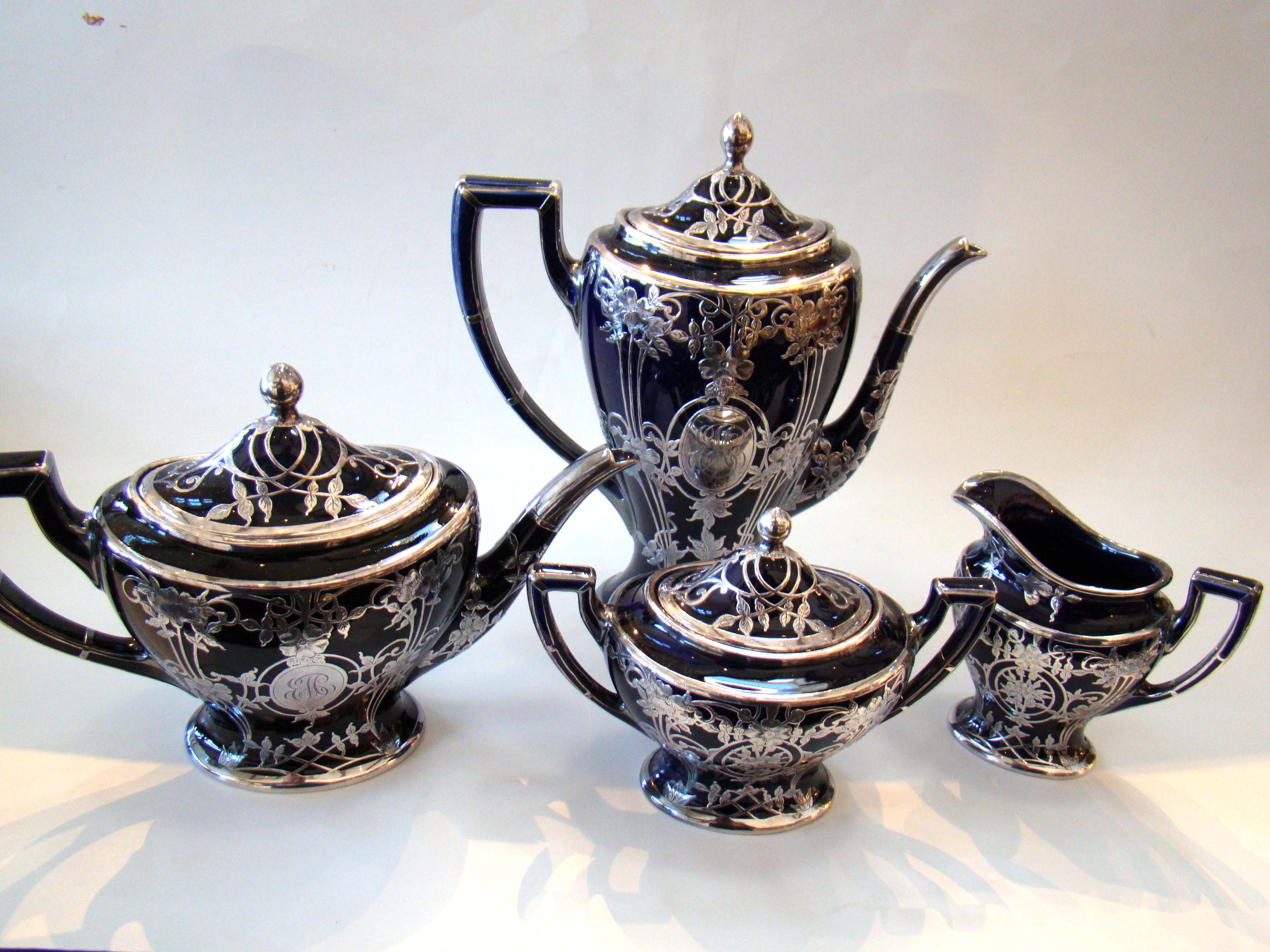 A stunning four-piece tea & coffee service in cobalt blue porcelain with silver overlay made by Lenox circa 1910