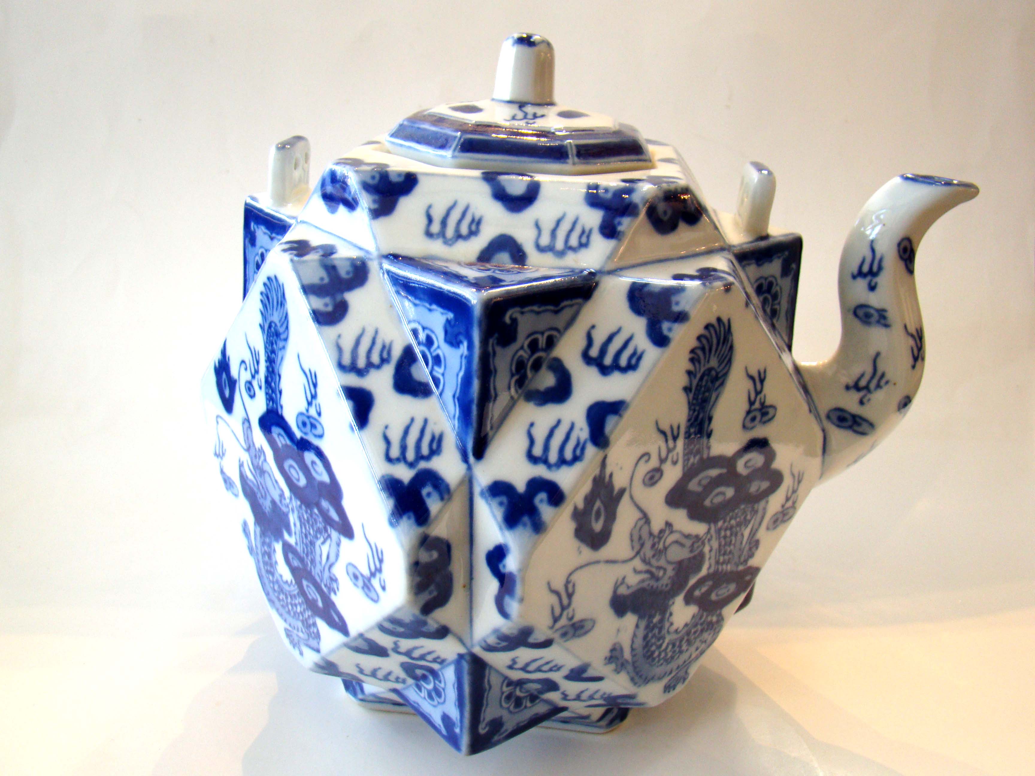 An unusual Chinese faceted square form teapot with dragon decoration