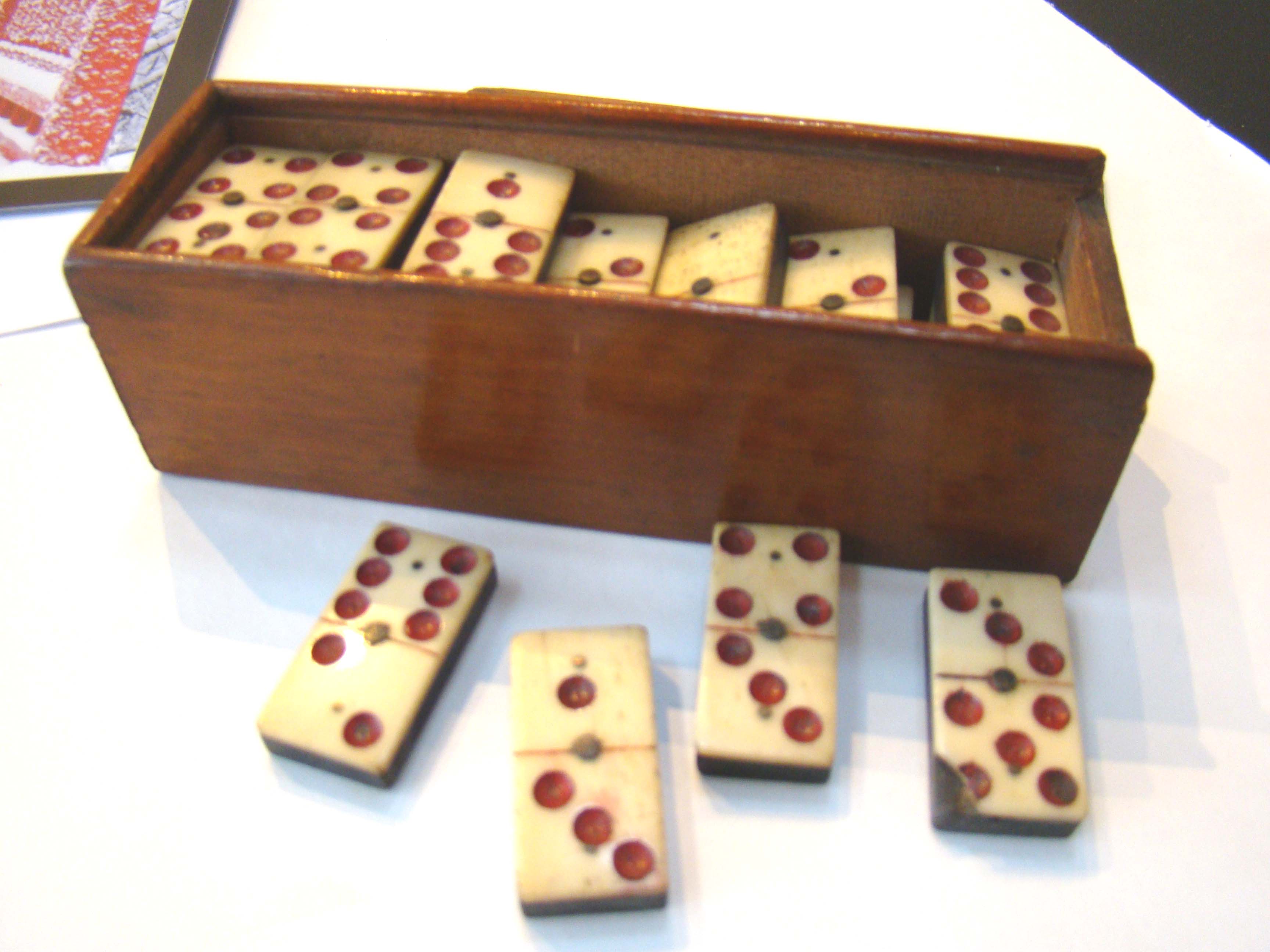A very good and complete set of Civil War era bone and ebony dominoes having red dots