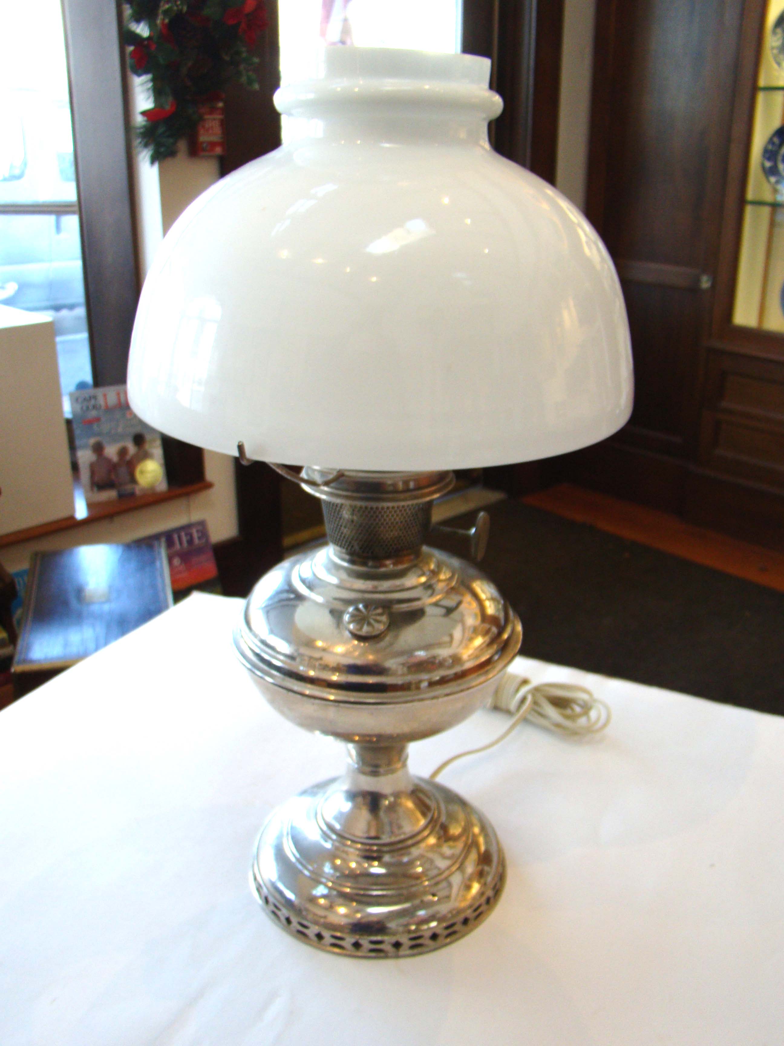 A very nice nickel silver plated Alladin Oil Lamp dated 1915 made by the Mantle Lamp Co.