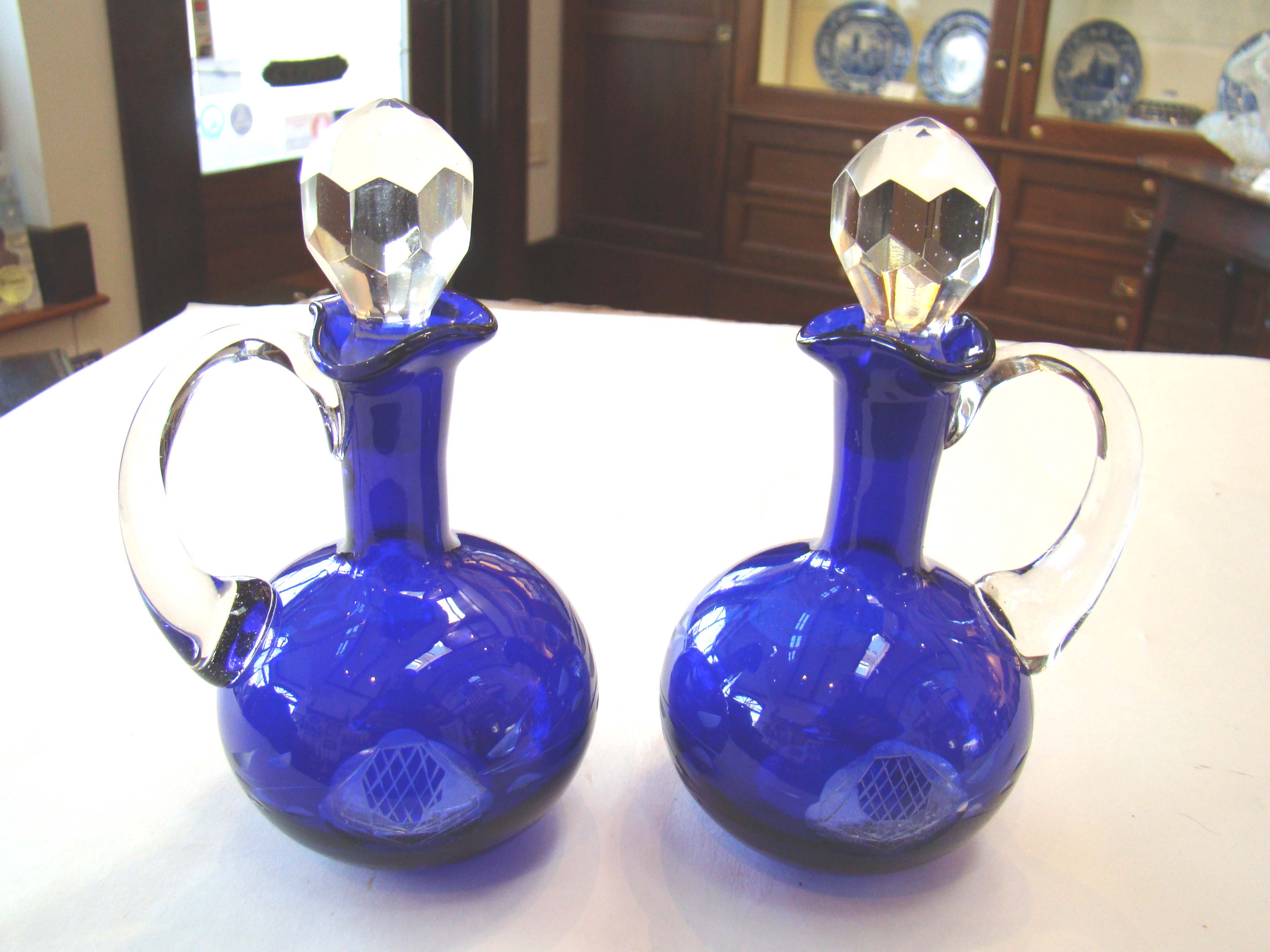 A beautiful pair of late 19th century etched cobalt blue cruet bottles