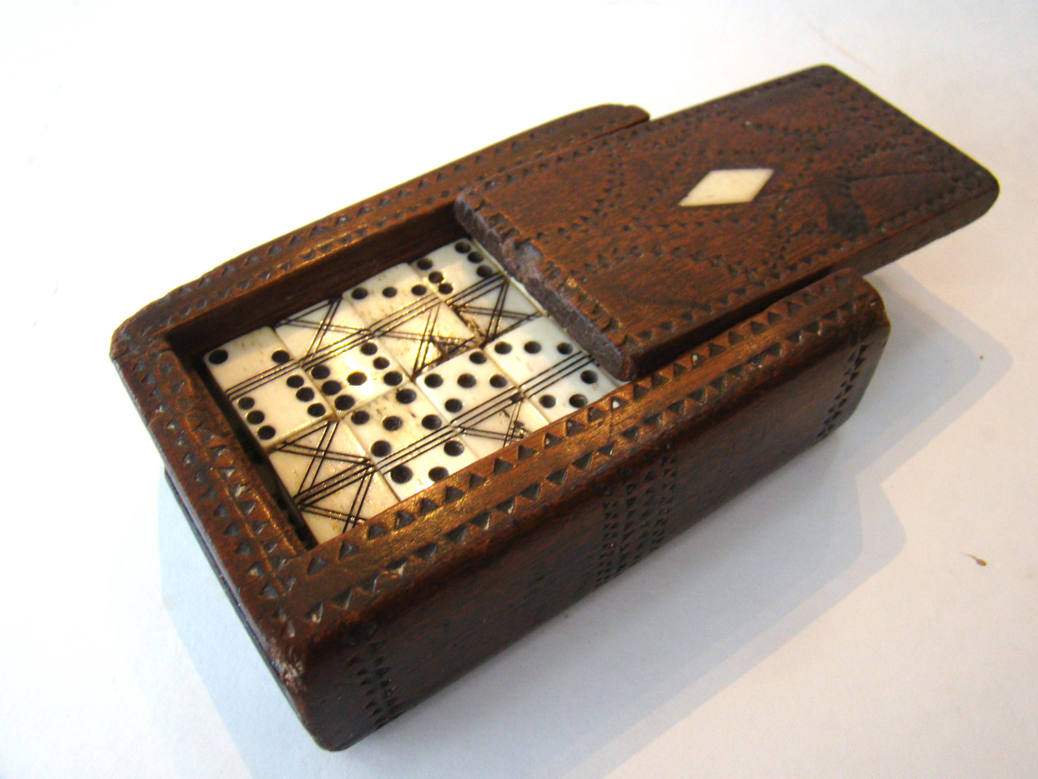 A Napoleonic period Prisoner-of-war carved wooden book-form game box circa 1800-1810