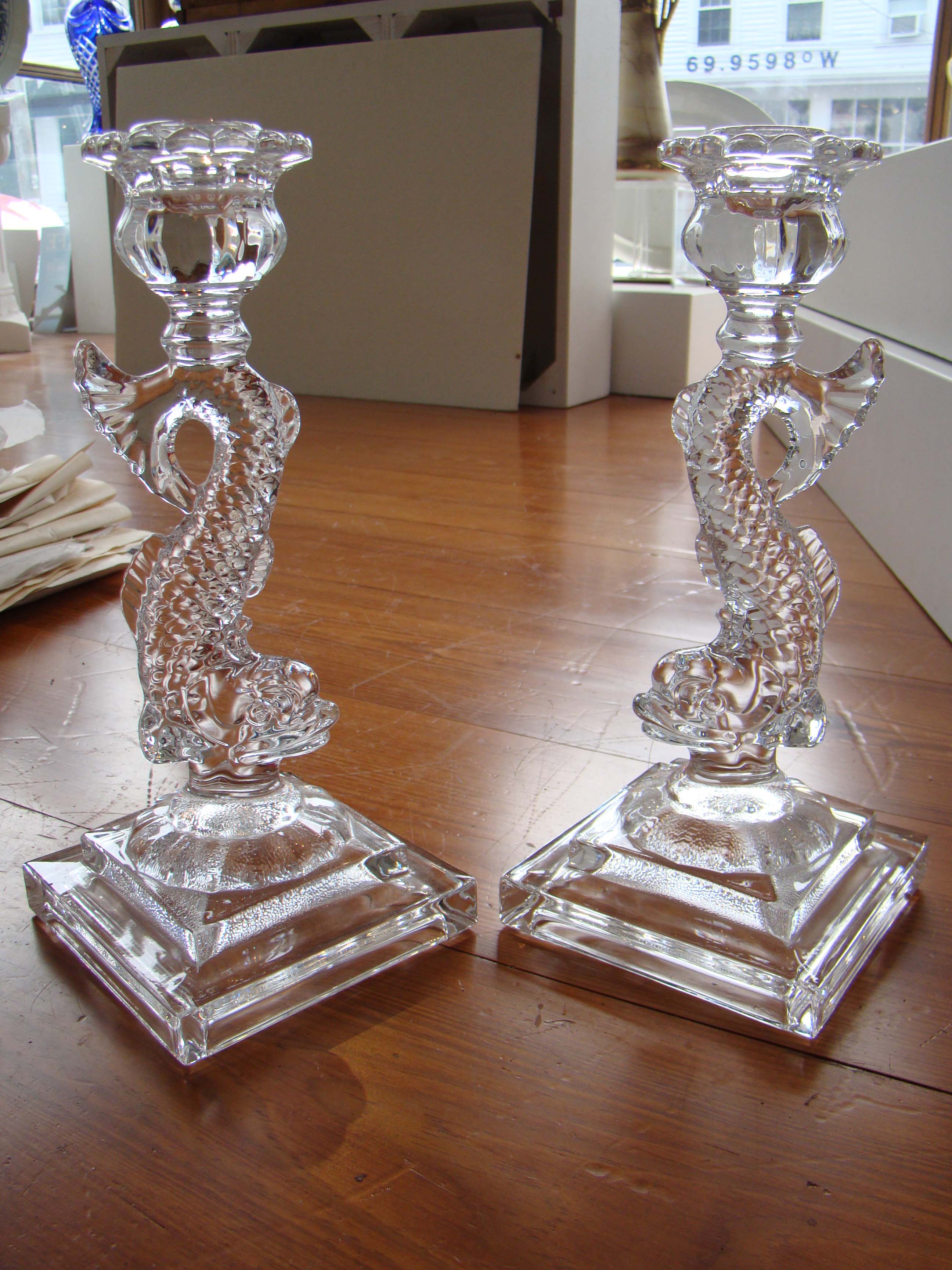 A fabulous pair of dolphin form crystal candlesticks