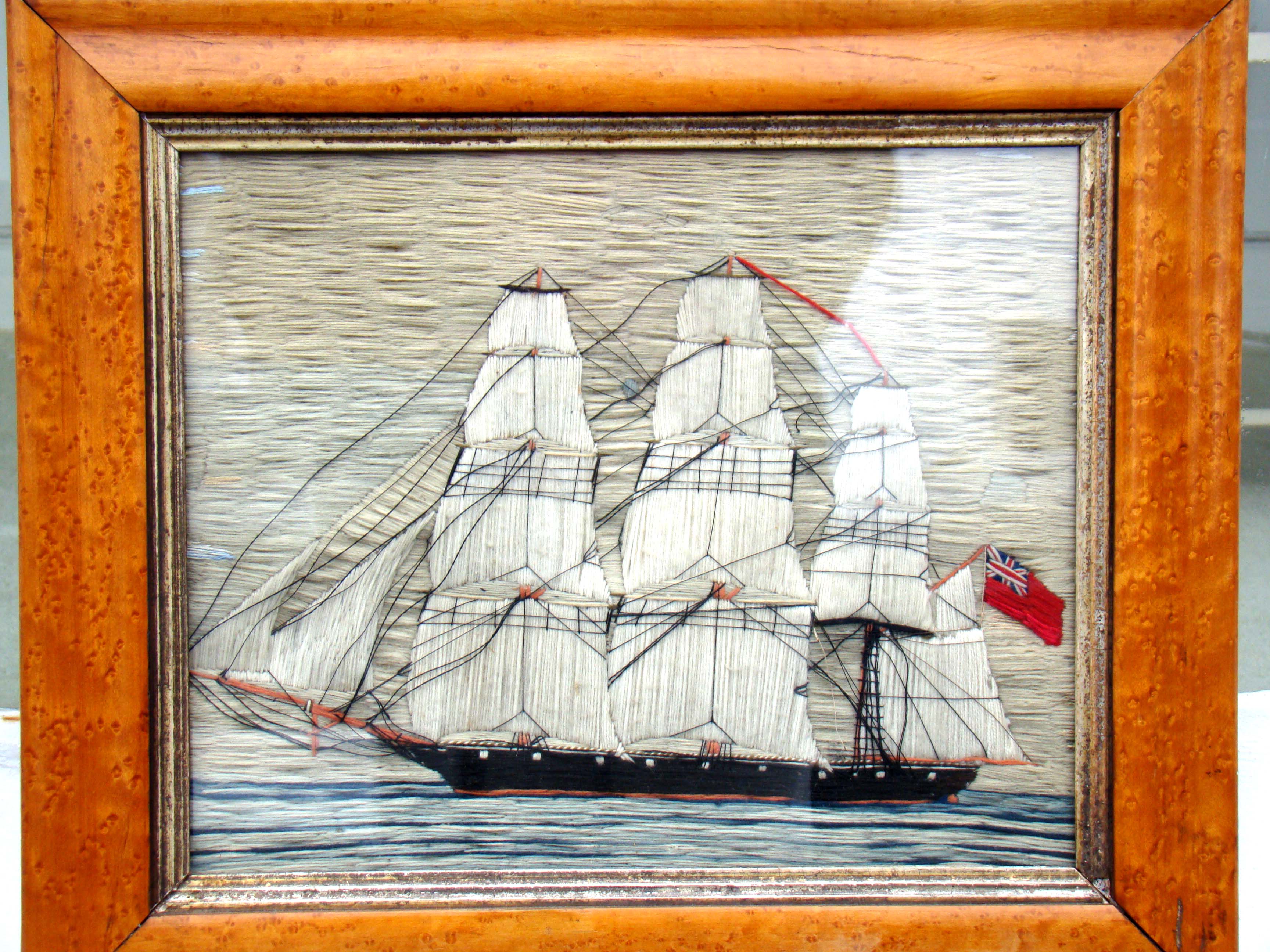 A fine small 19th century sailor's woolwork picture of a British three-masted ship circa 1870