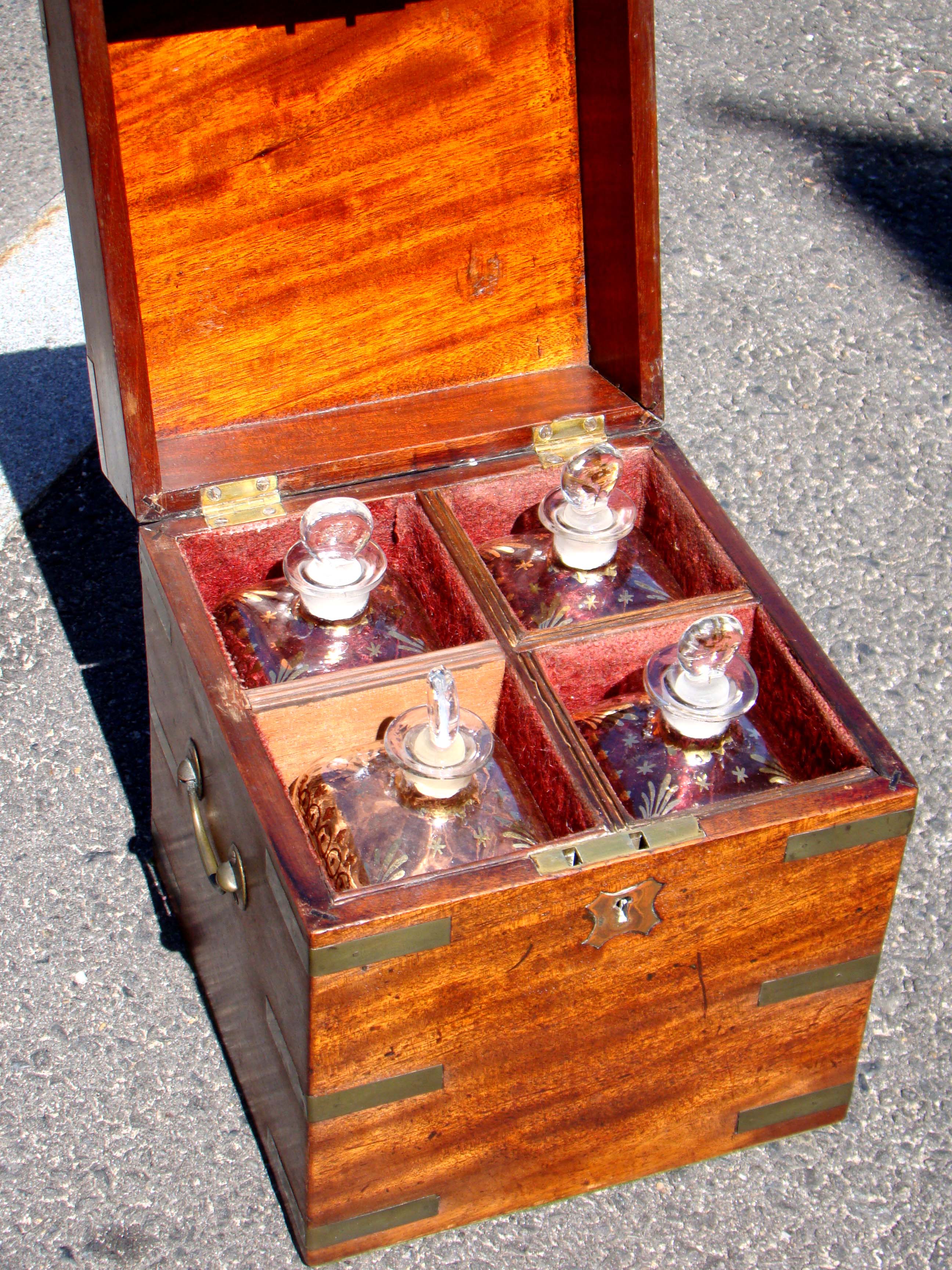 An early 19th century Captain's brass mounted mahogany liquor box with its' original decanters circa 1830