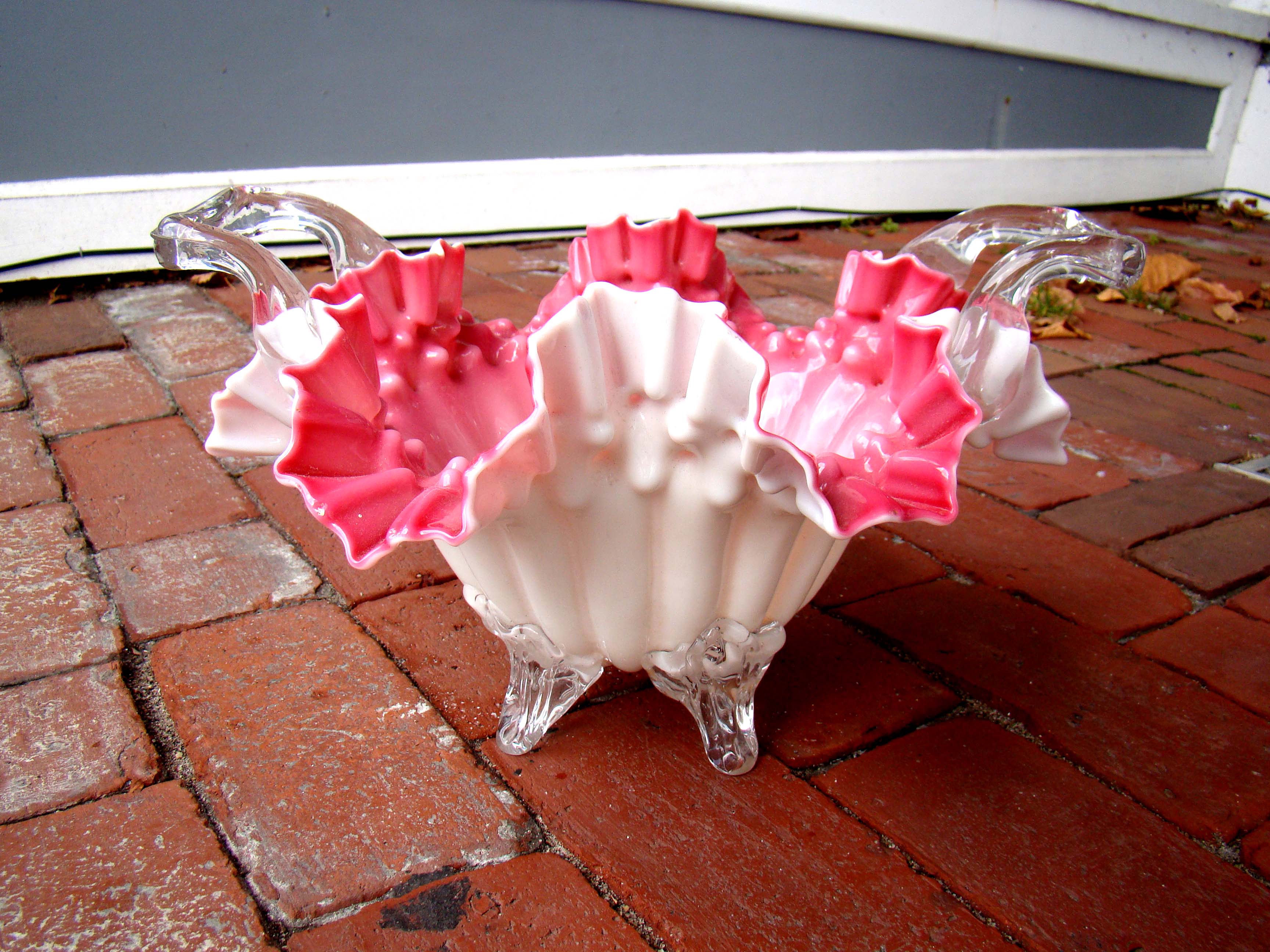 A fine vintage FENTON pink ruffle edge footed basket with applied handles