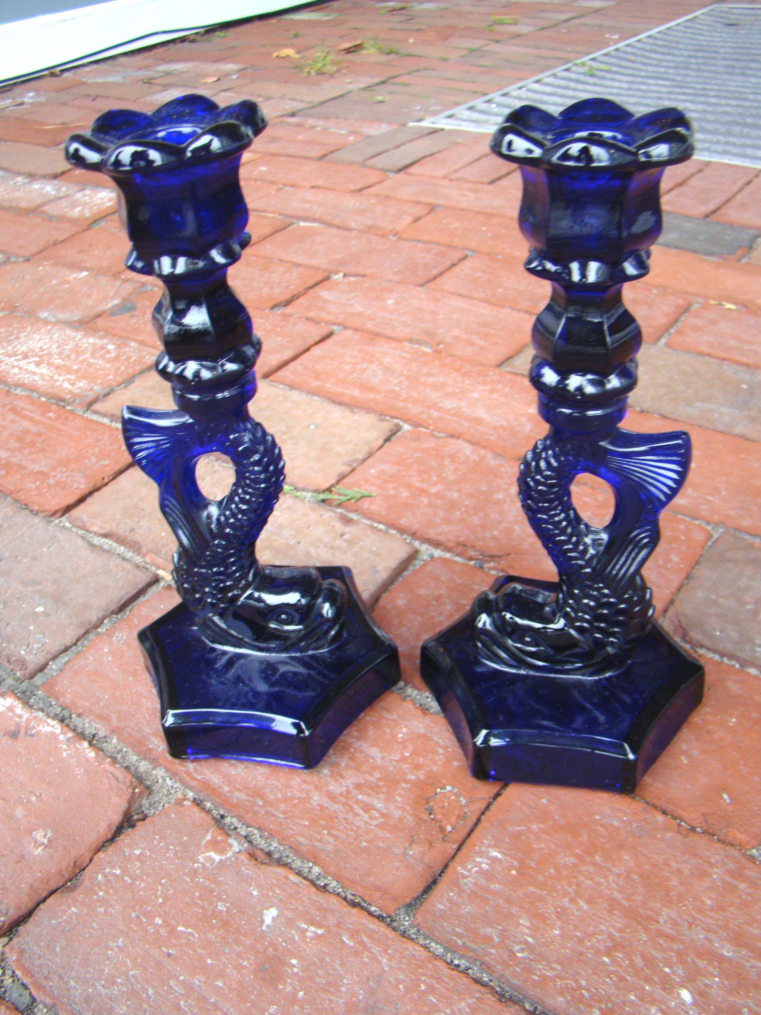 A beautiful pair of vintage cobalt blue glass dolphin form candlesticks