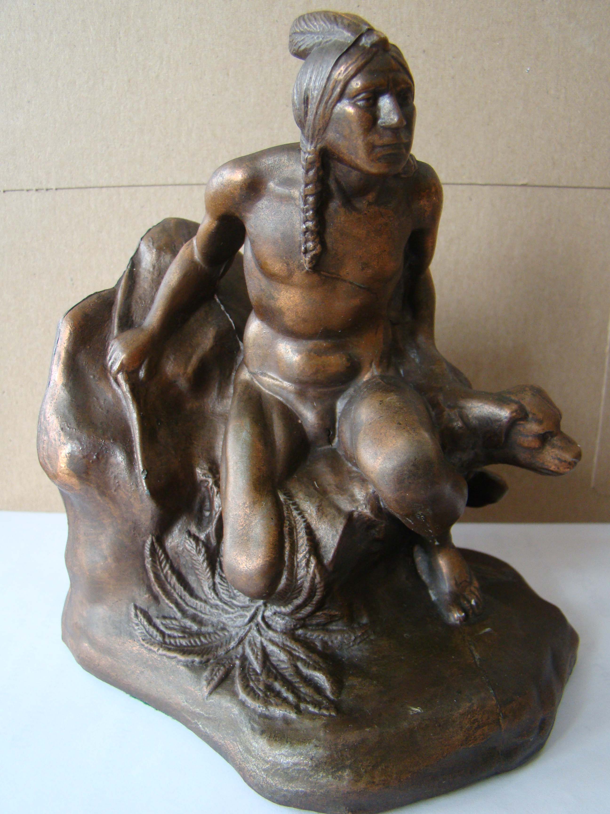A single vintage bookend made circa 1930 depicting an Indian and his dog stalking prey