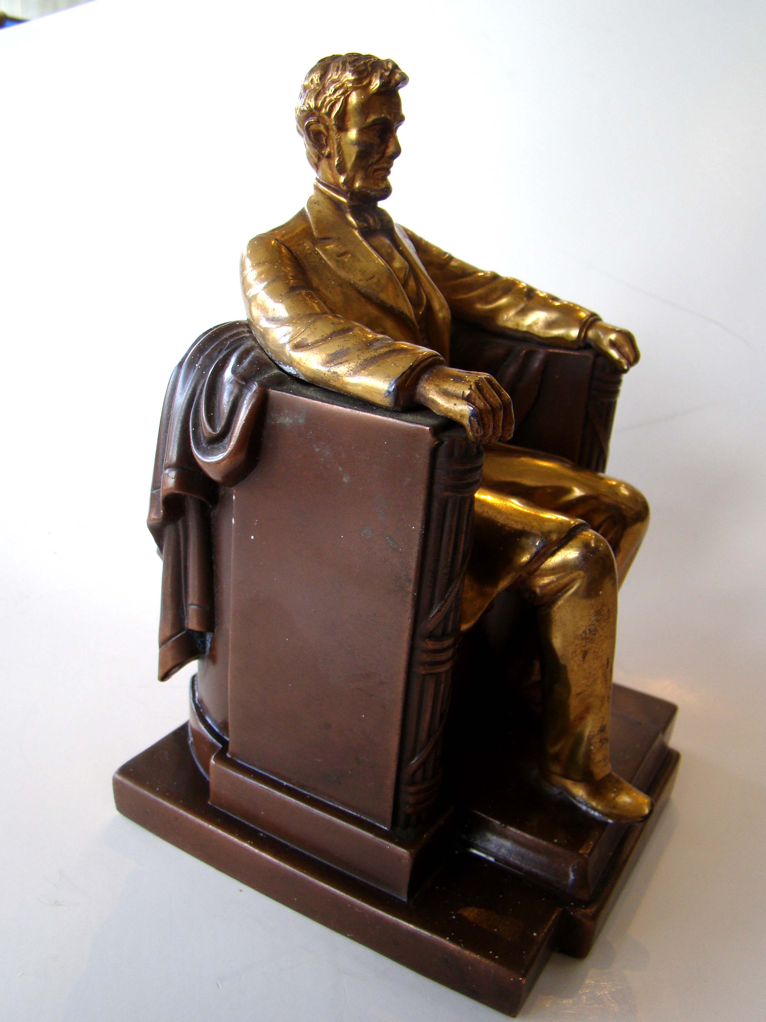 A fine single bookend made circa 1930 depicting Abraham Lincoln sitting in his chair