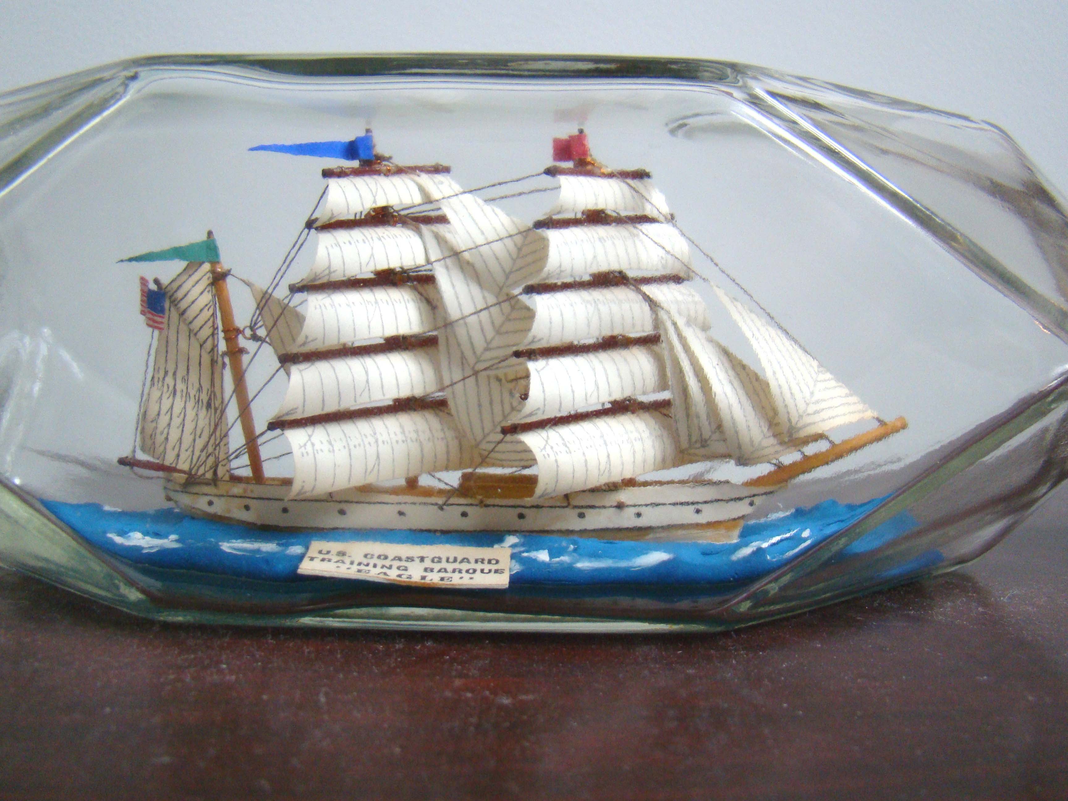 A fine vintage SHIP-IN-A BOTTLE depicting the U S Coast Guard Academy's sail training ship the EAGLE