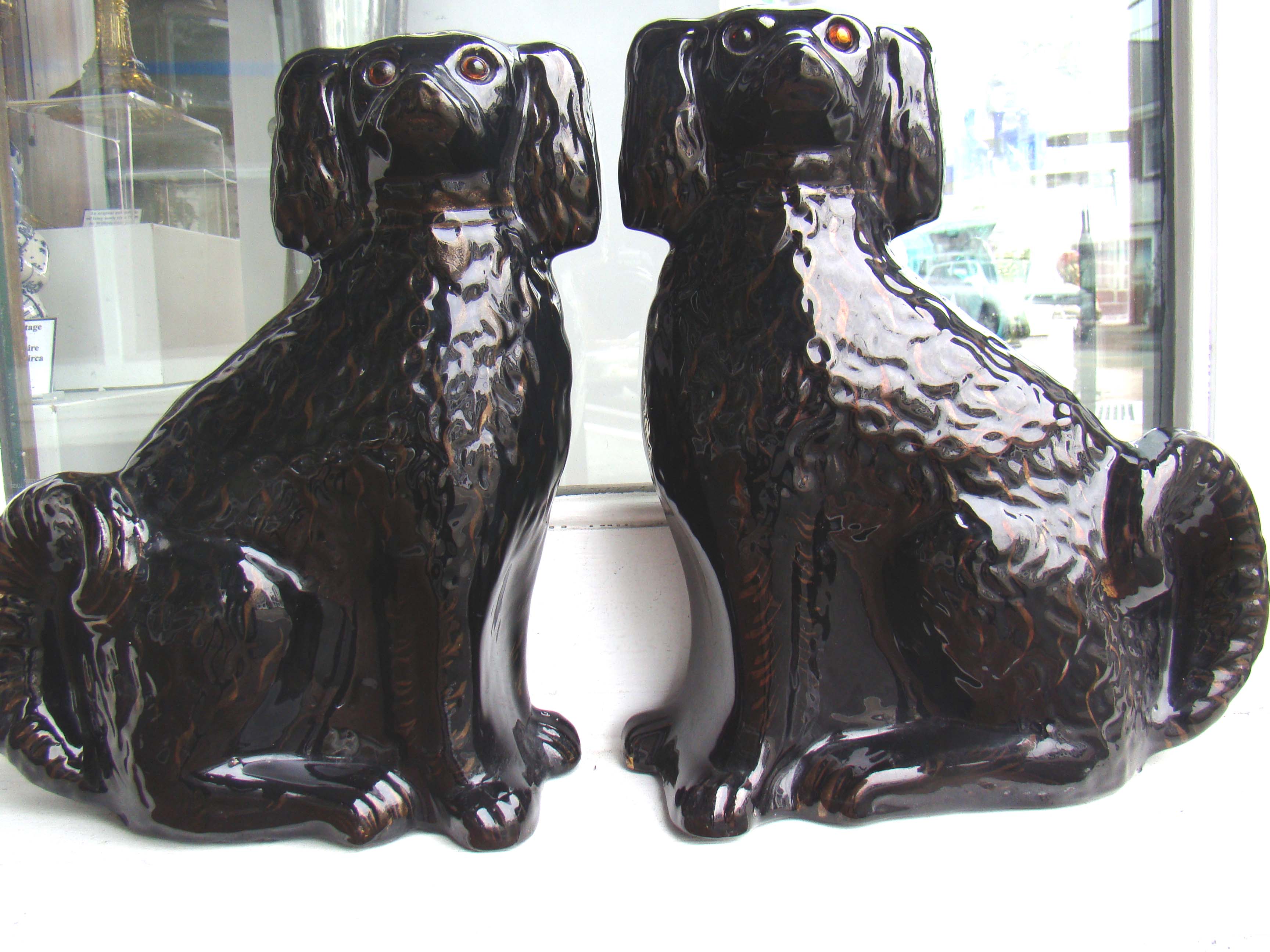 A rare pair of 19th century Black Staffordshire Cavalier King Charles Spaniel mantle dogs