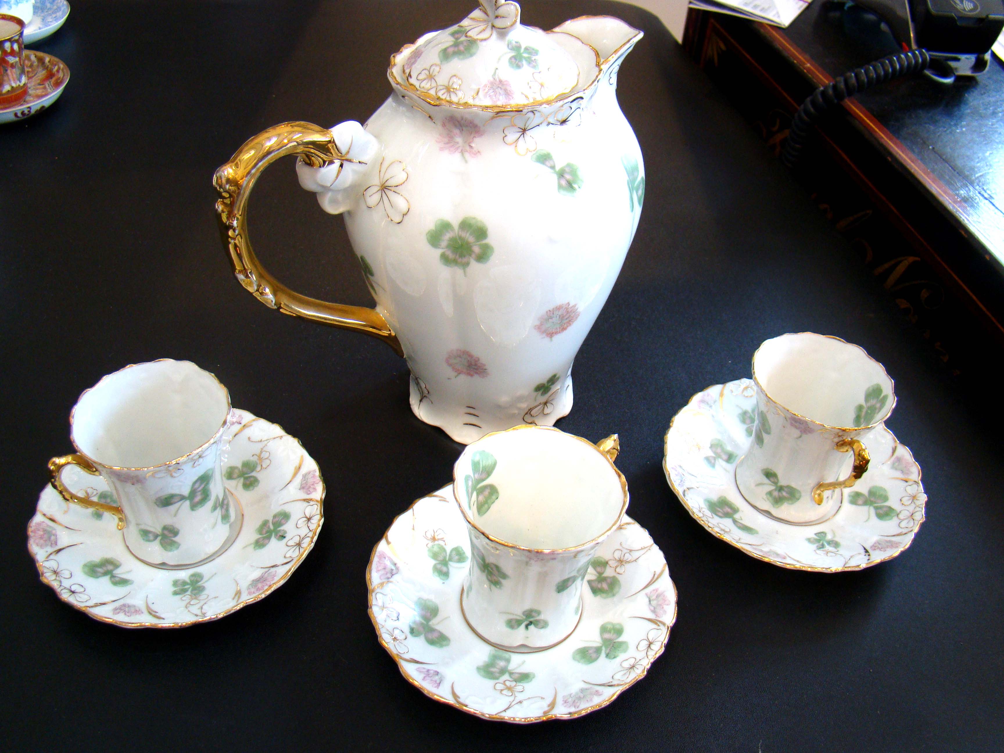 A fabulous vintage "GOOD LUCK" German porcelain tea/coffee pot with three matching cups & saucers