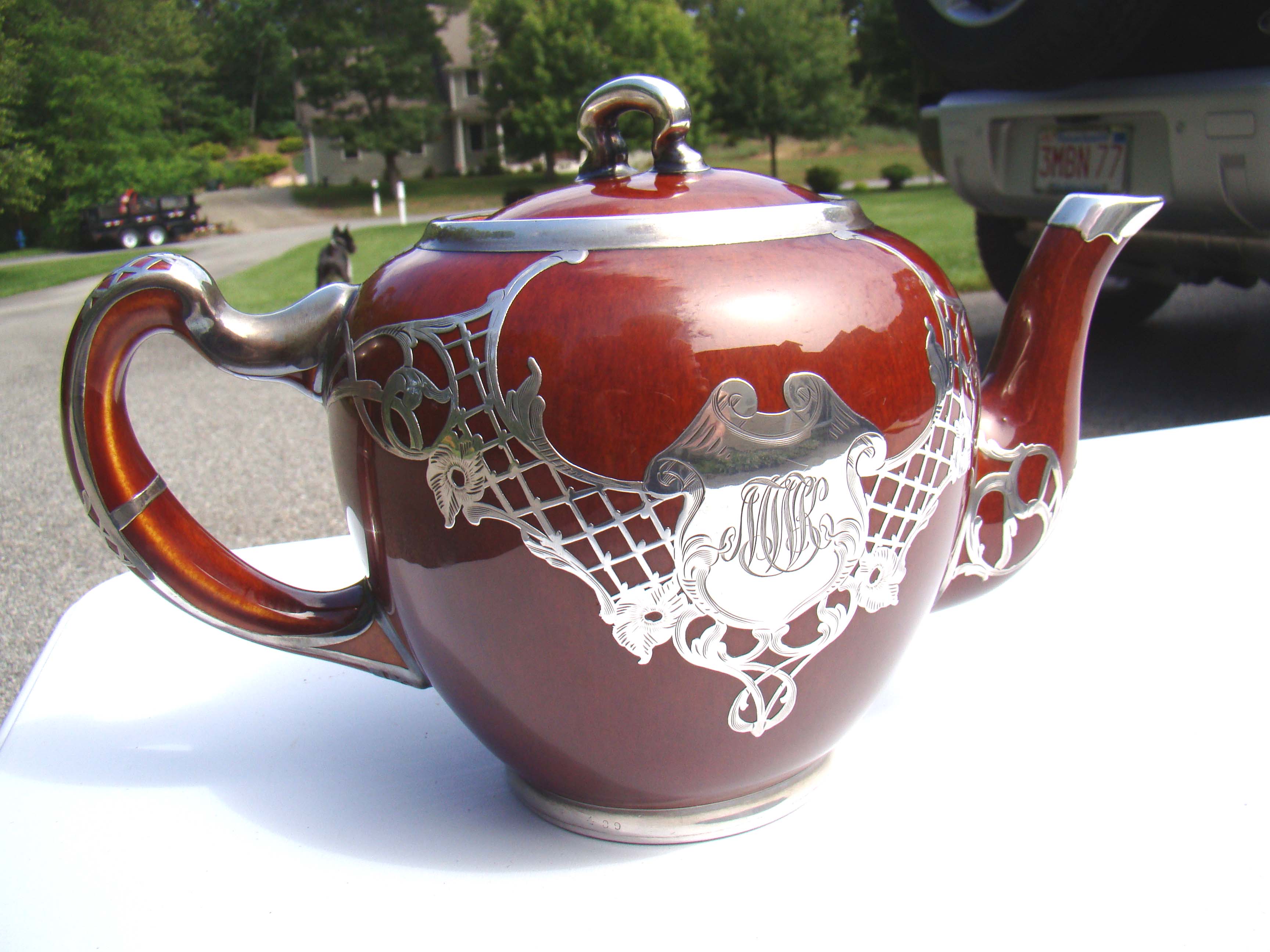 A FABULOUS brown glazed silver mounted teapot made by Gibson Pottery circa 1890