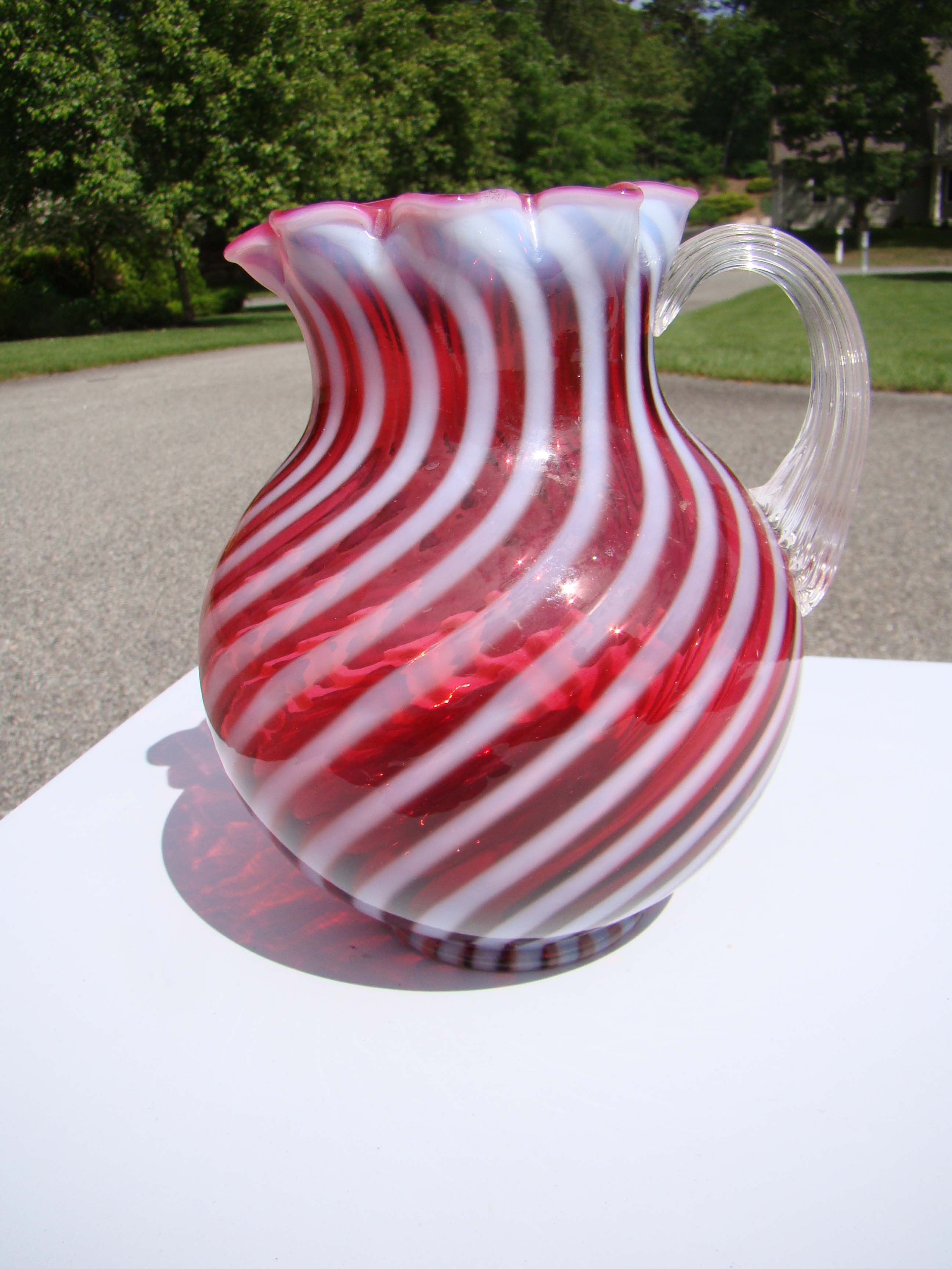 A fine vintage cranberry swirl glass pitcher