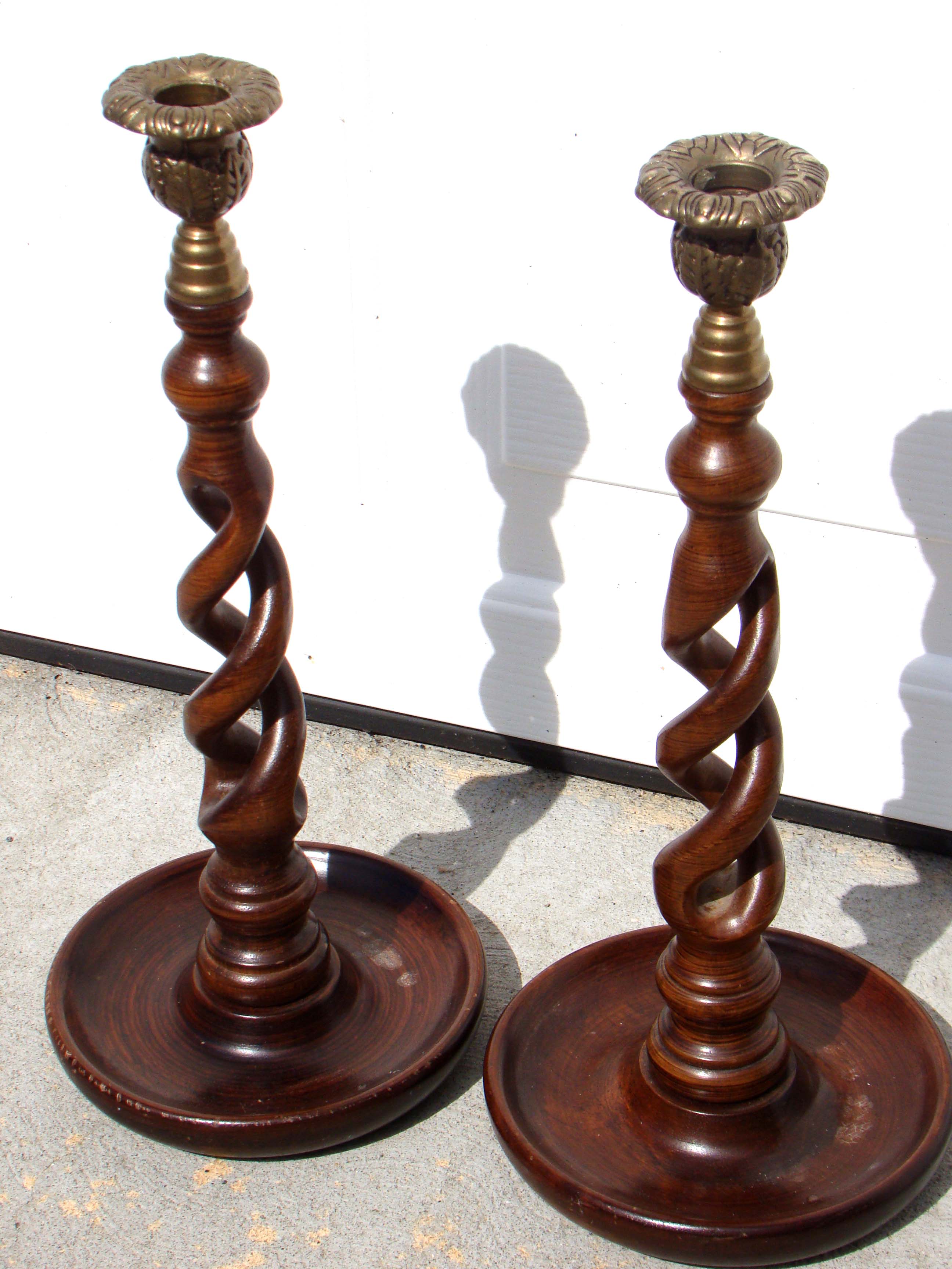 An attractive pair of Edwardian style barley twist candlesticks with brass bobeches