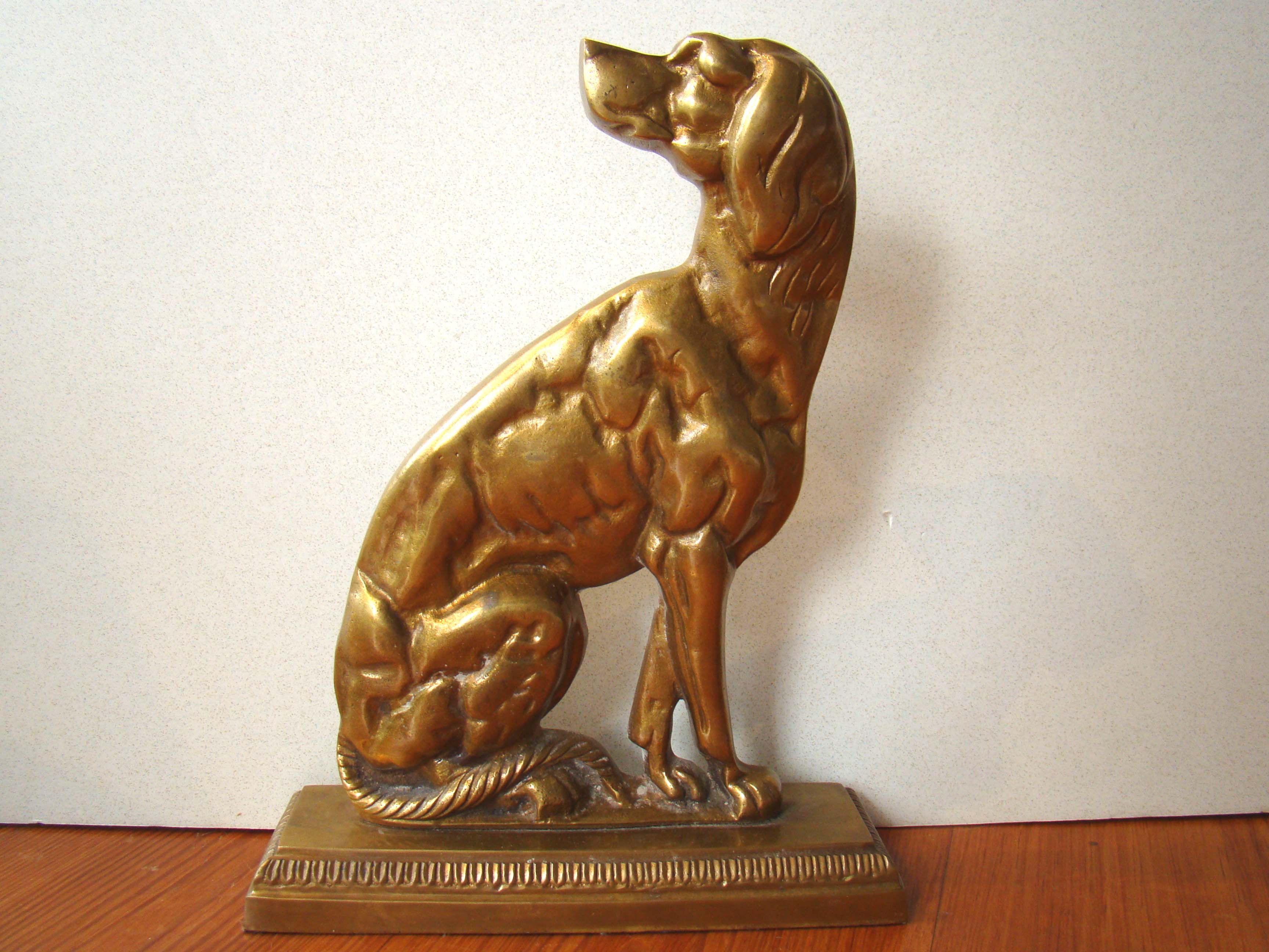 A charming vintage gilt brass setter doorstop