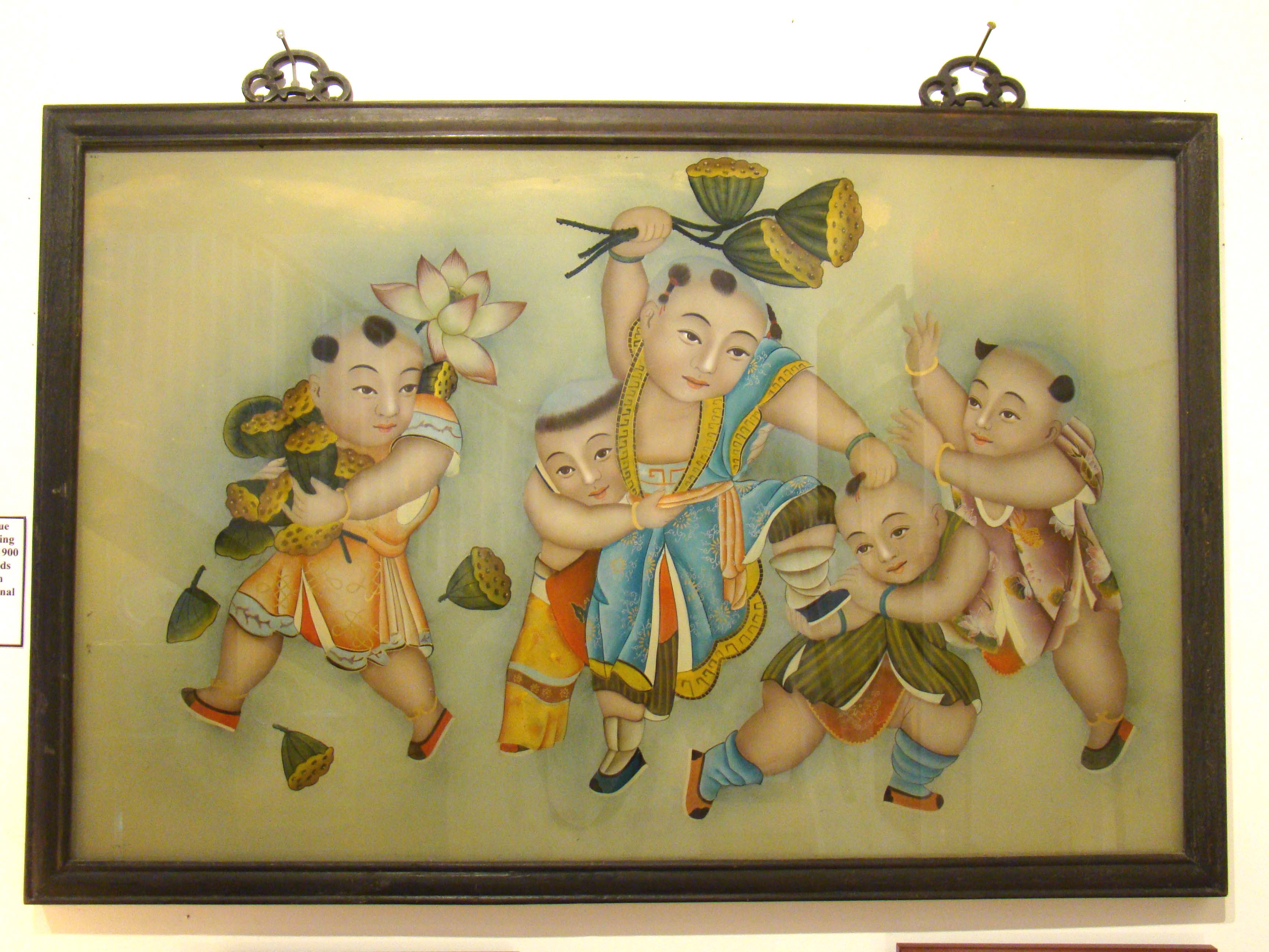 A fine Chinese painting on glass featuring children playing and lotus seeds circa 1900