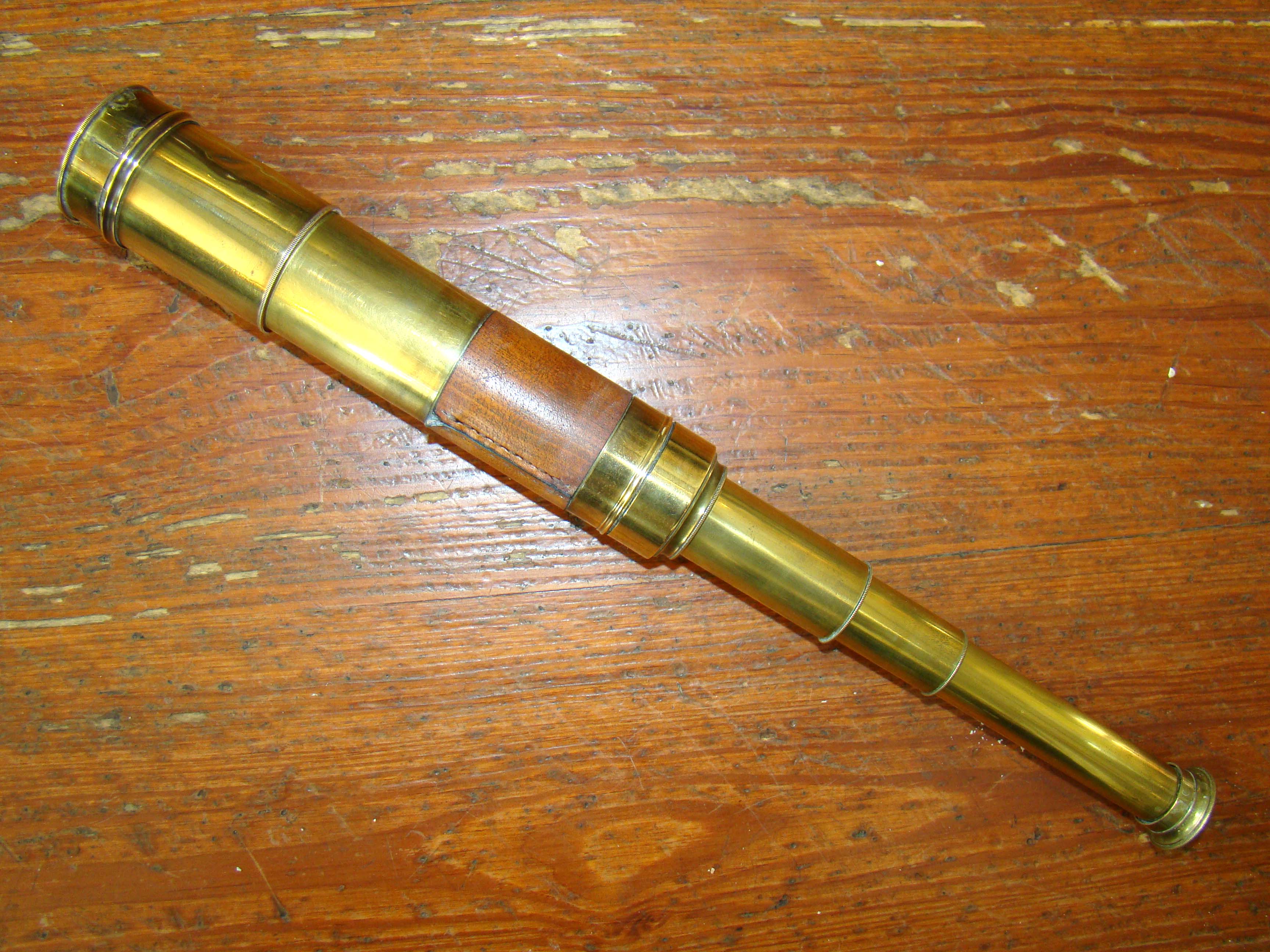 An English three-draw telescope with leather wrapped barrel circa 1830