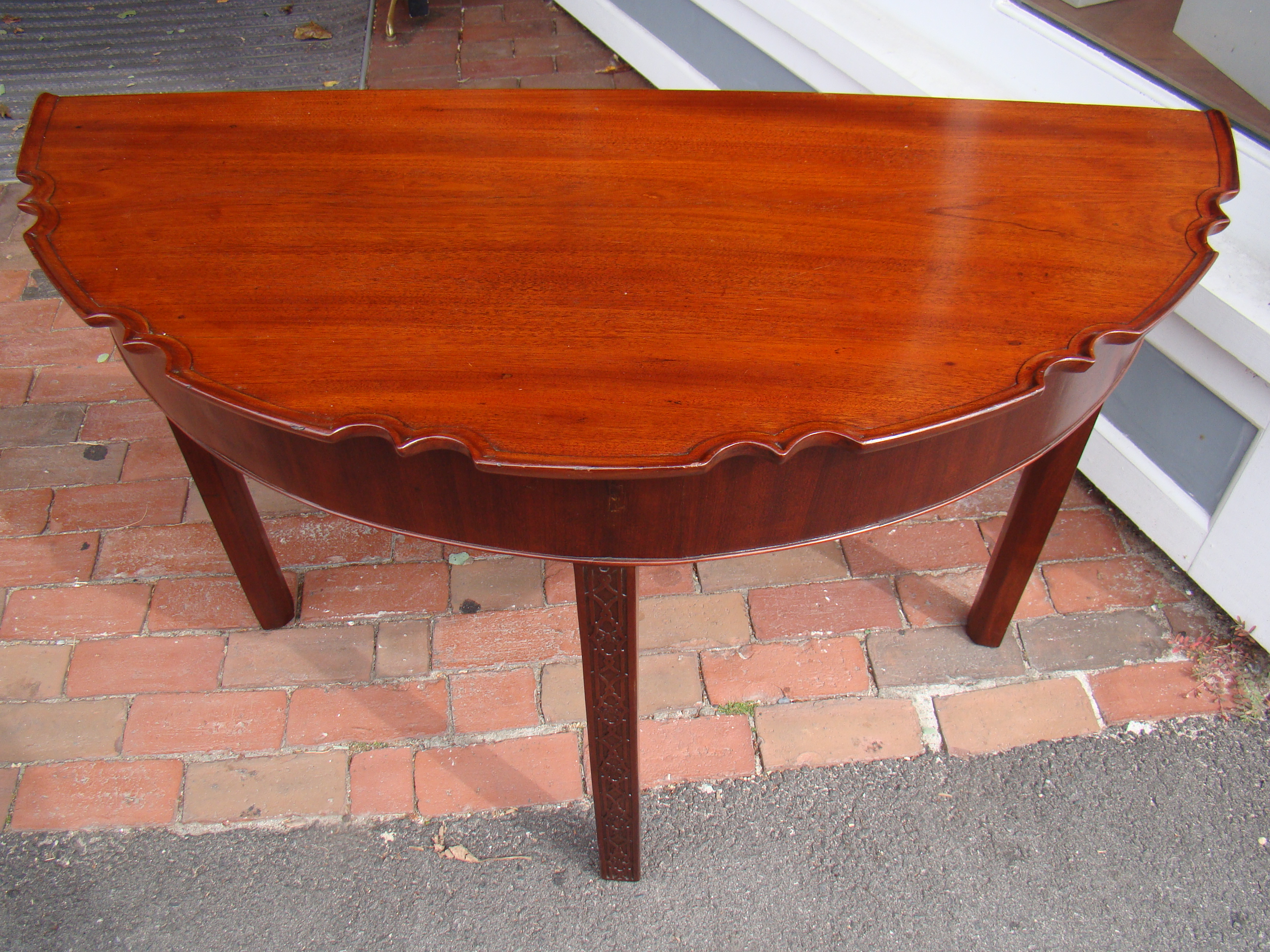 A fine 18th century English "Chinese Chippendale" mahogany demilune table