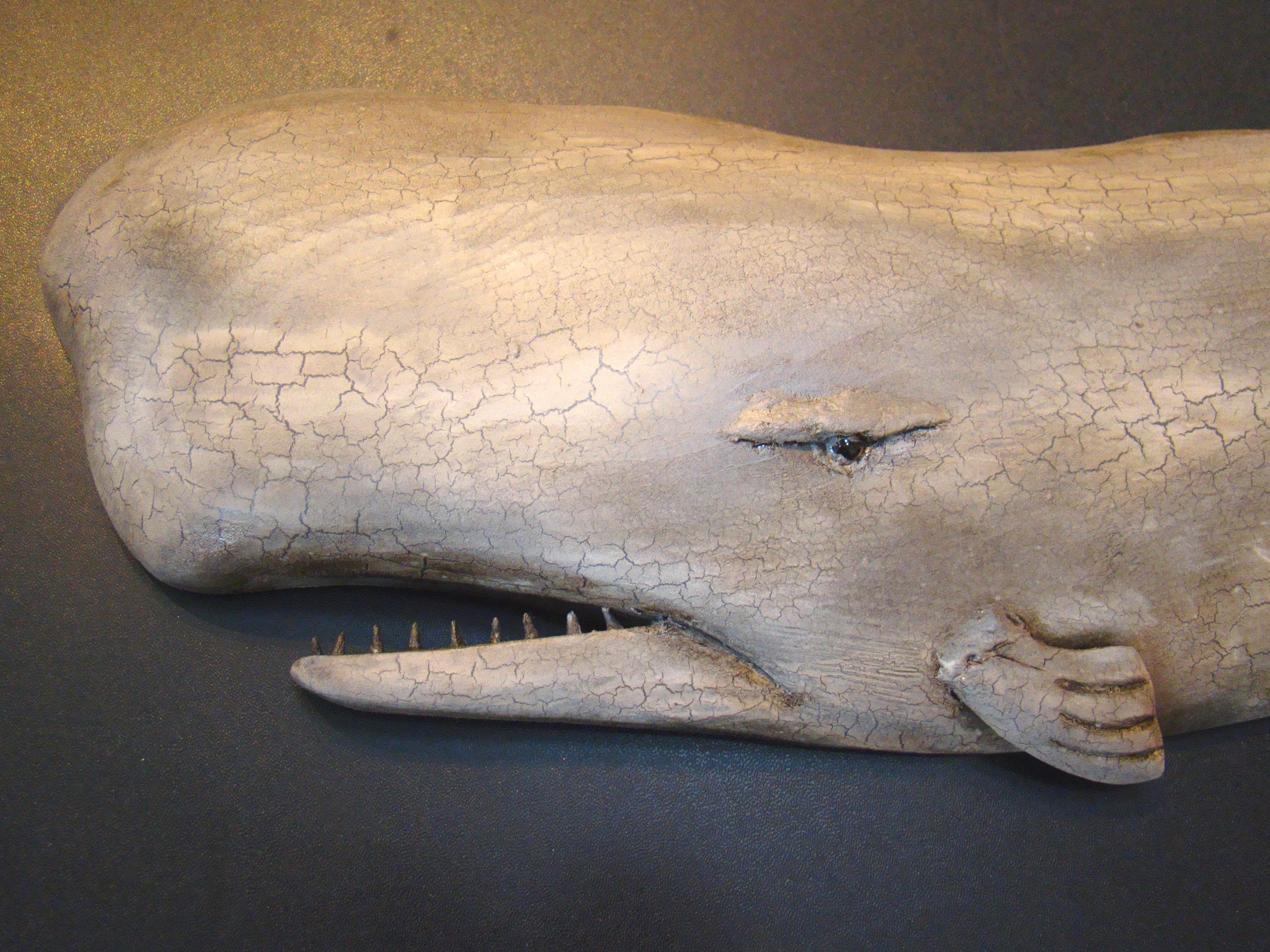 A charming carved sperm whale plaque by noted wood carver Roger Mitchell