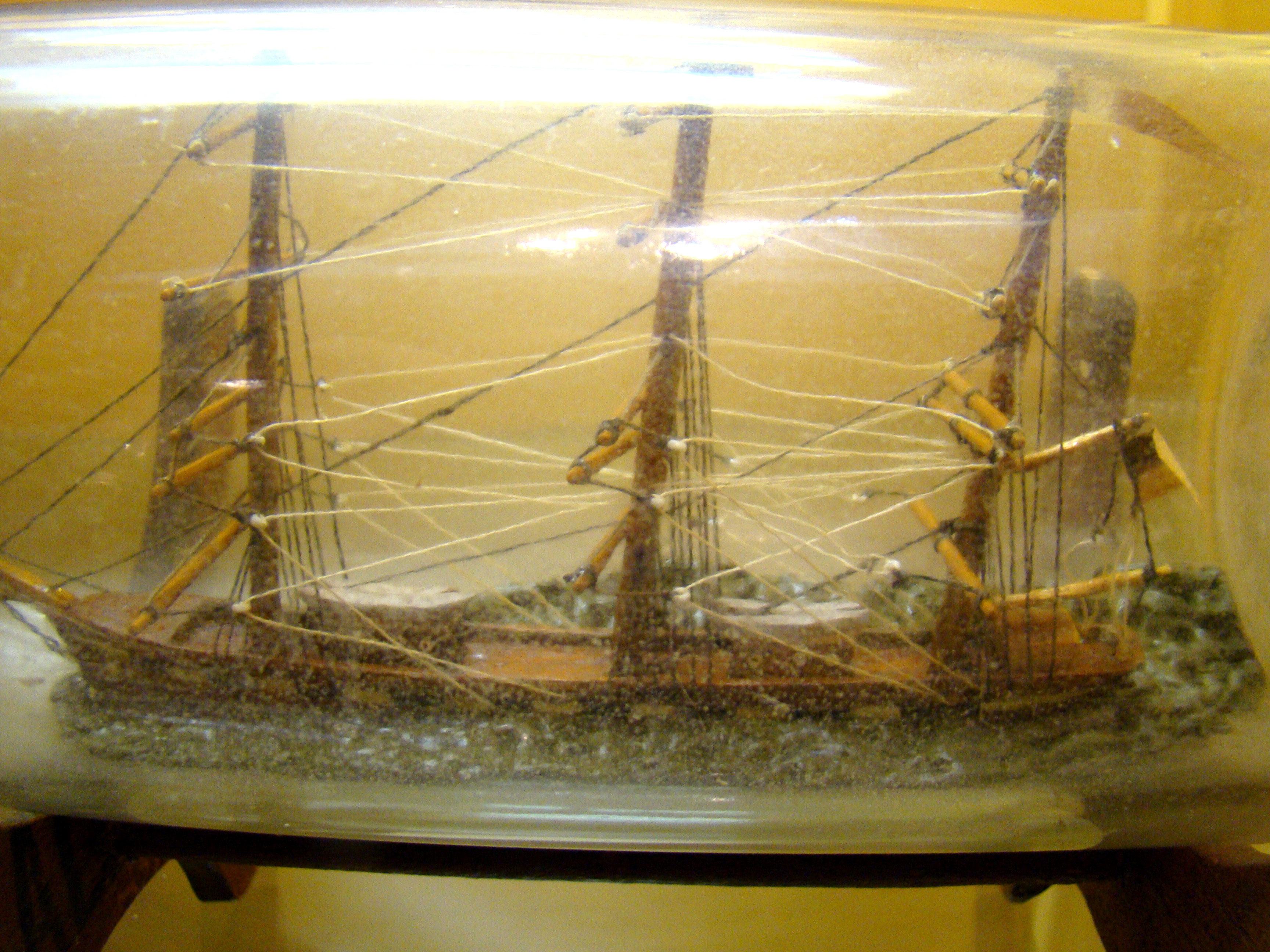 A late 19th century ship-in-a bottle flying an American flag circa 1890