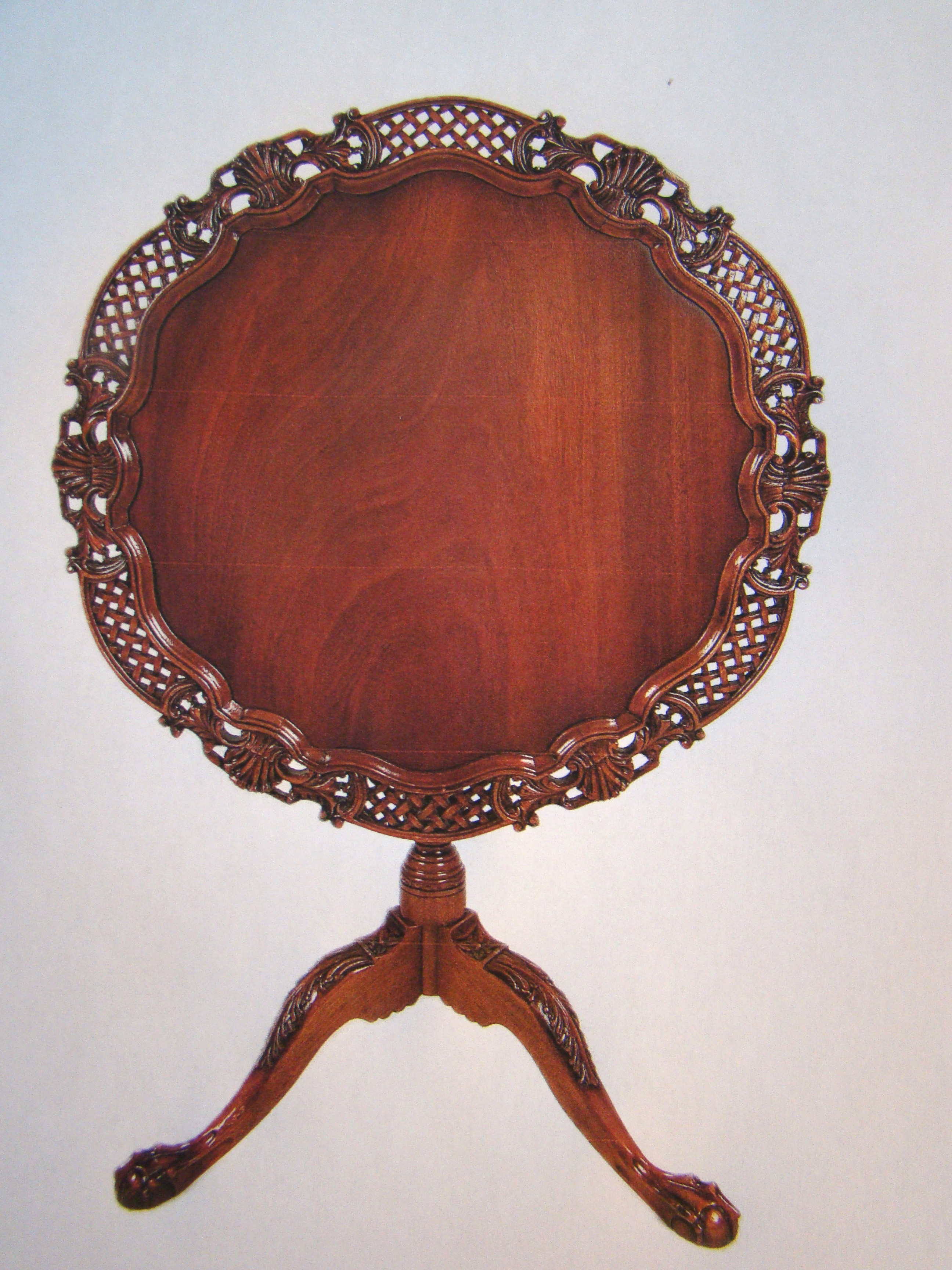 An ornately carved Chippendale-style tilt-top table, mid 20th century