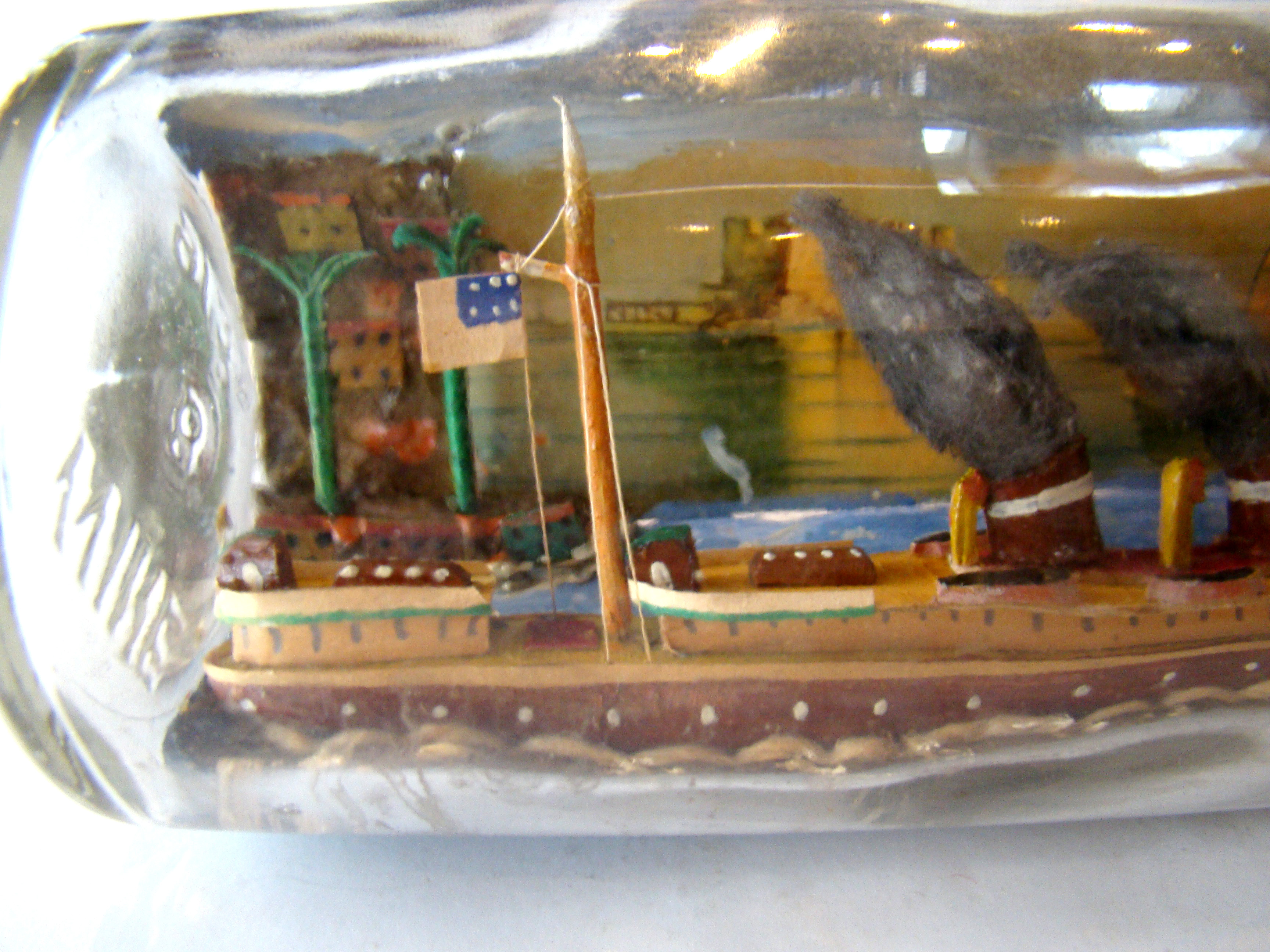 A fine vintage sailor-made two-funnel steam ship flying an American flag with village scene in the background — image 2