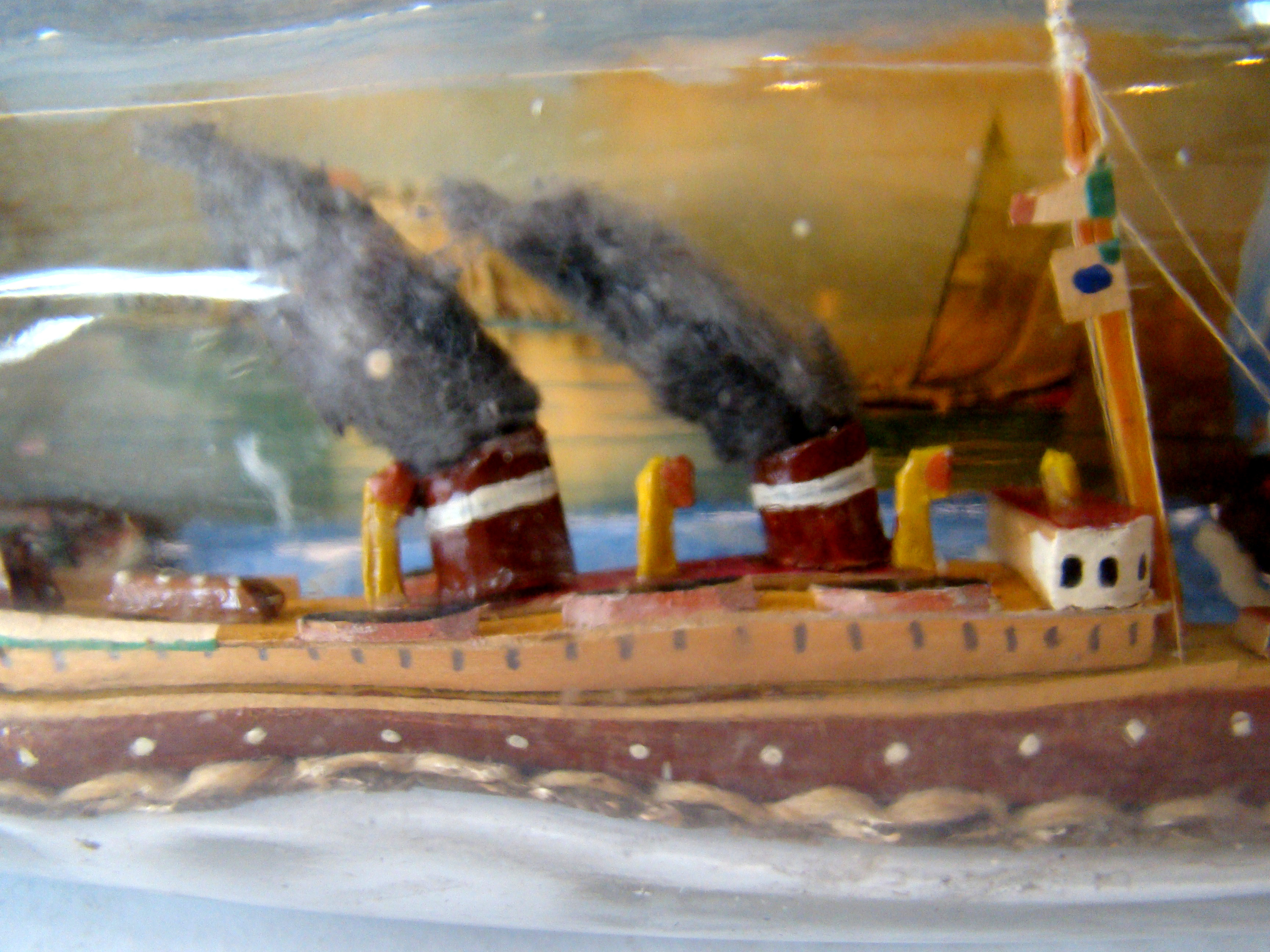 A fine vintage sailor-made two-funnel steam ship flying an American flag with village scene in the background — image 4