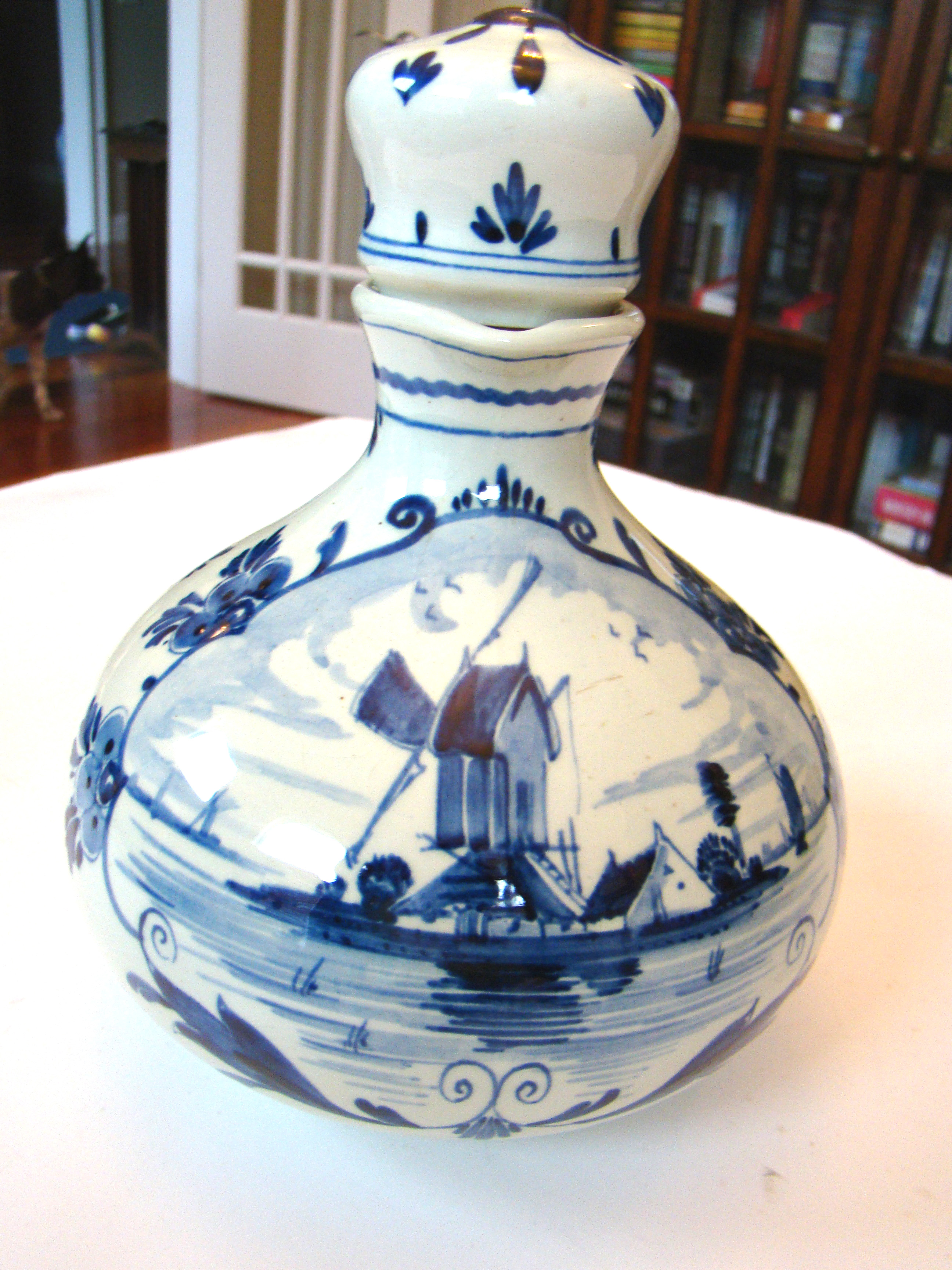 An attractive Dutch Delft liquor bottle featuring a scene of old Amsterdam circa 1575