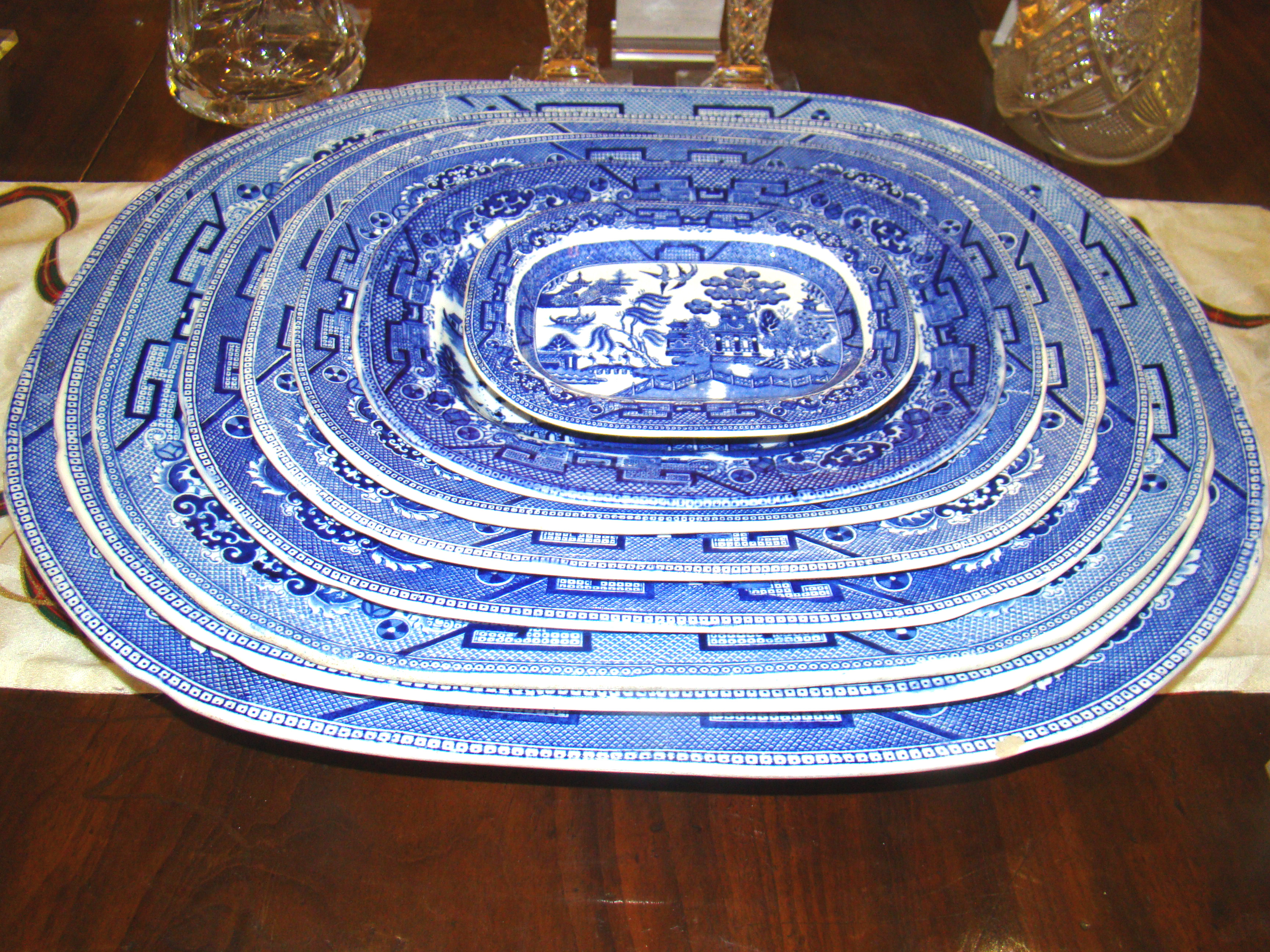 A fabulous assembled graduated set of 8 antique blue willow serving platters circa 1880-1900