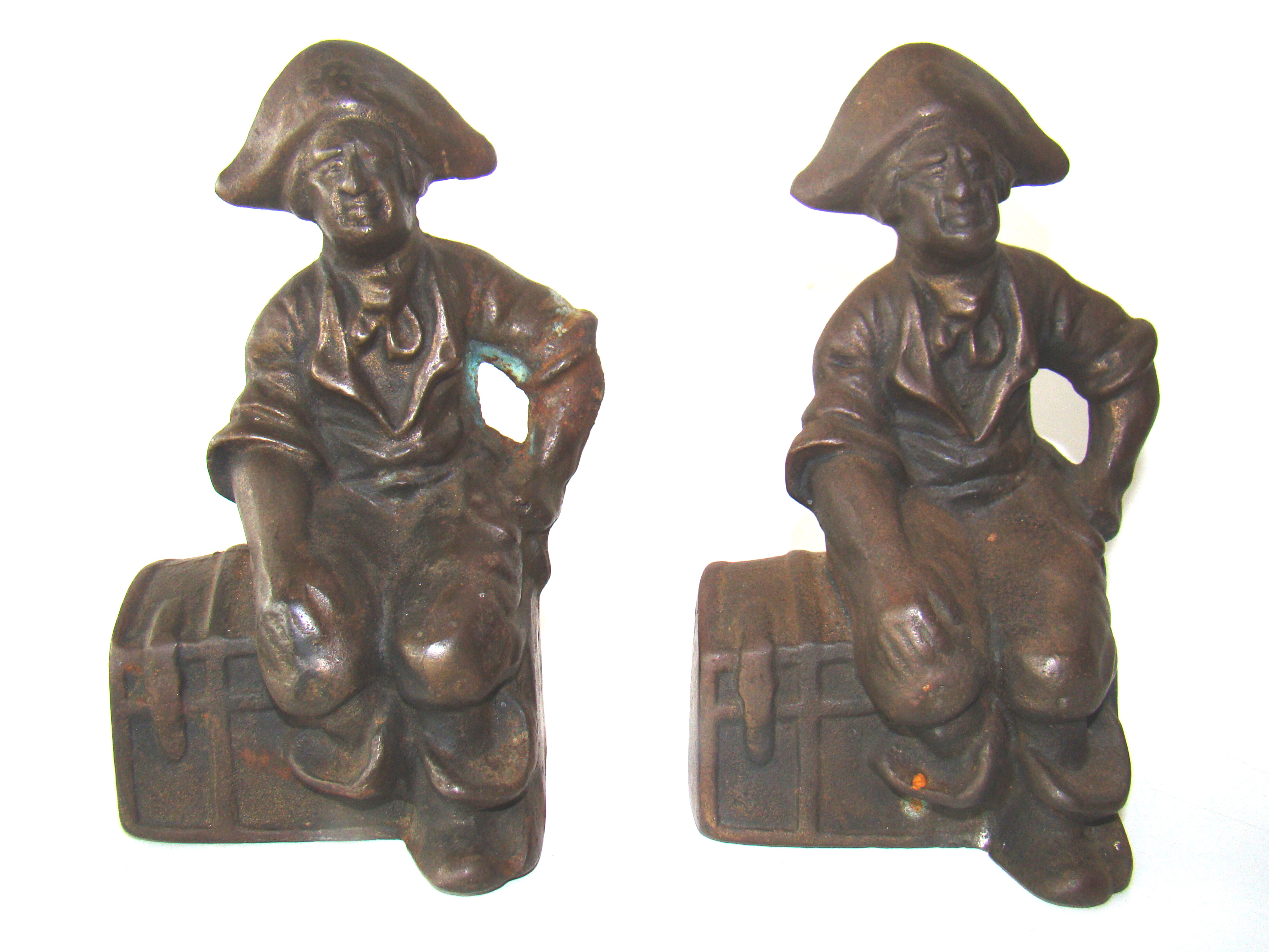 A pair of vintage cast iron Pirate sitting on a treasure chest bookends circa 1920